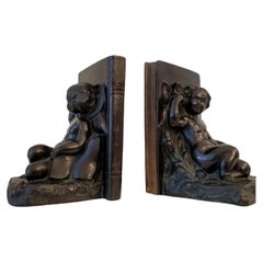 Amerikanisches Art-Déco-Buchstützenpaar Ronson Cherub & Schmetterling aus patinierter Bronze, 1920er Jahre