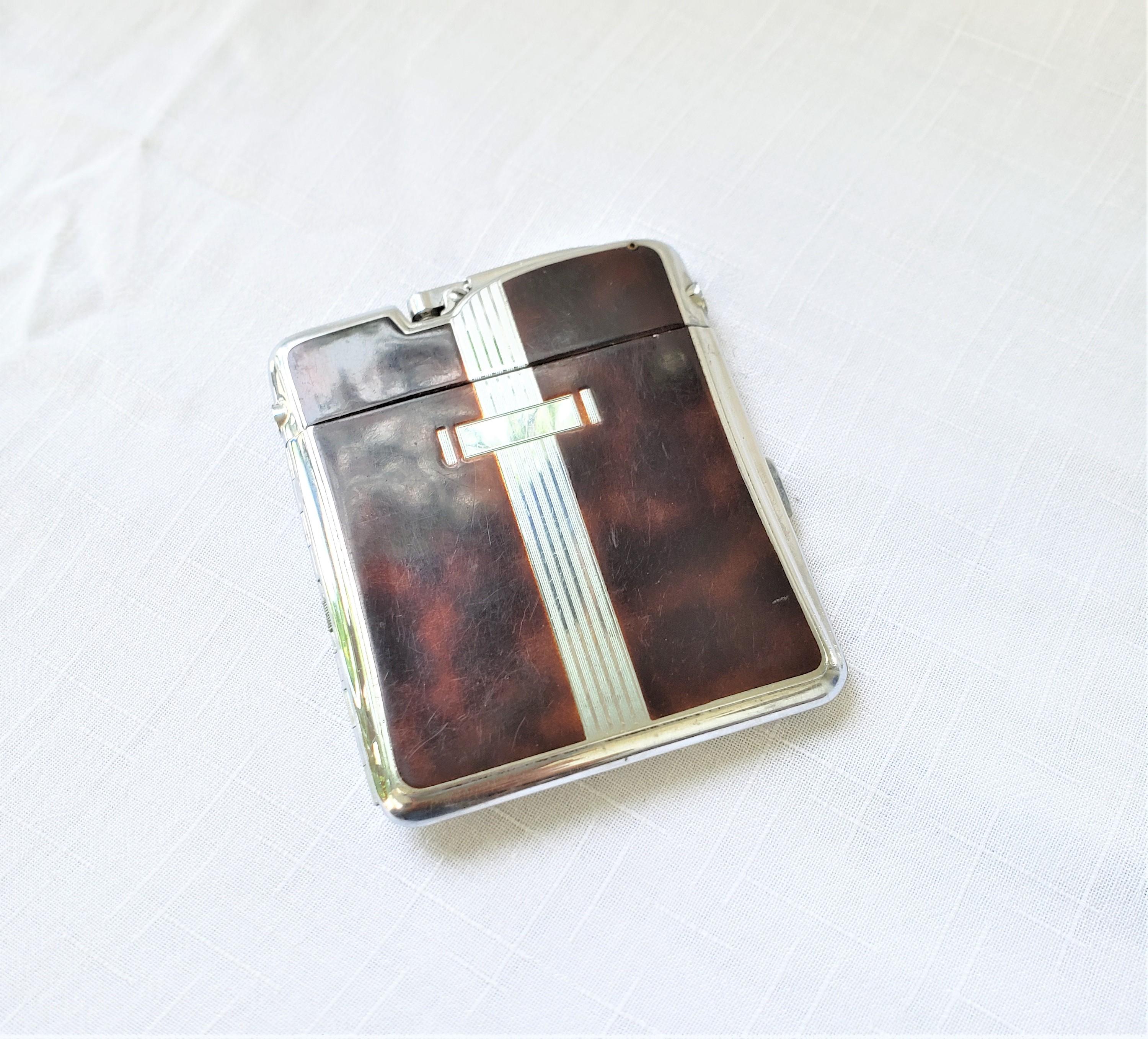 This vintage combination cigarette case and lighter was made by the well known Ronson's Dominion Art Metal Works division and dates to approximately 1965 and done in the period Mid-Century Modern style. The case and lighter are composed of chrome