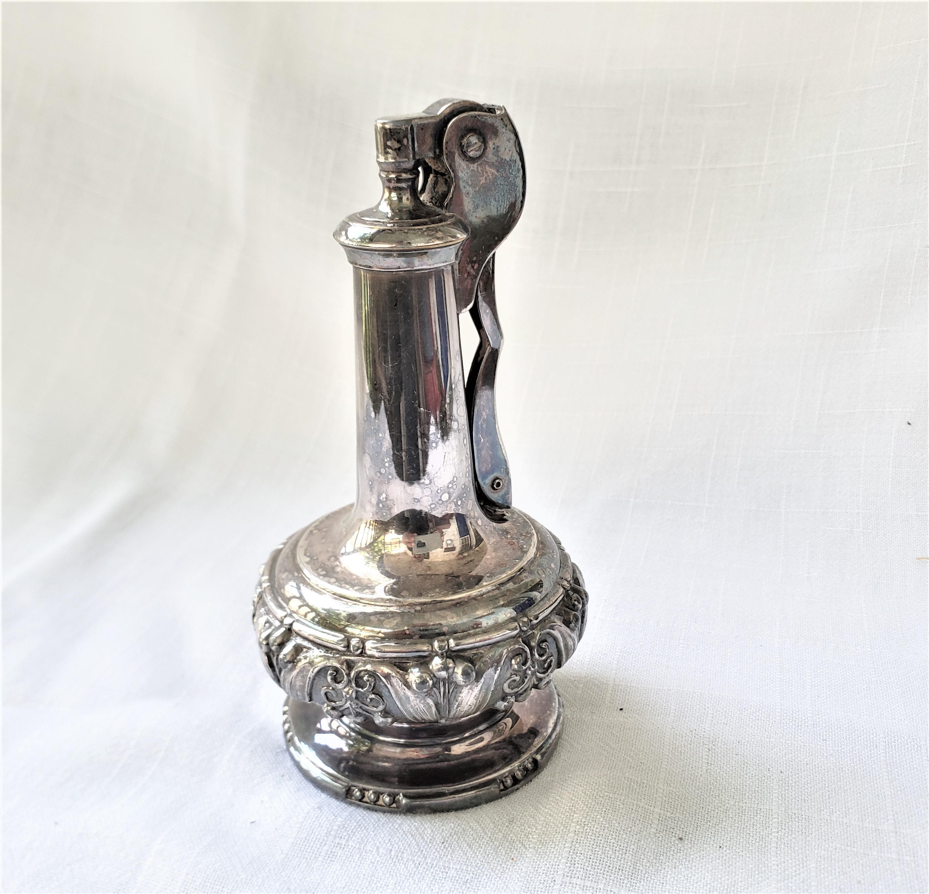 This table lighter was manufactured by Ronson of Canada and dates to approximately 1965 and done in the period Mid-Century Modern style. The lighter is composed of a cast and silver plated base with a spring loaded handle mechanism. This vintage