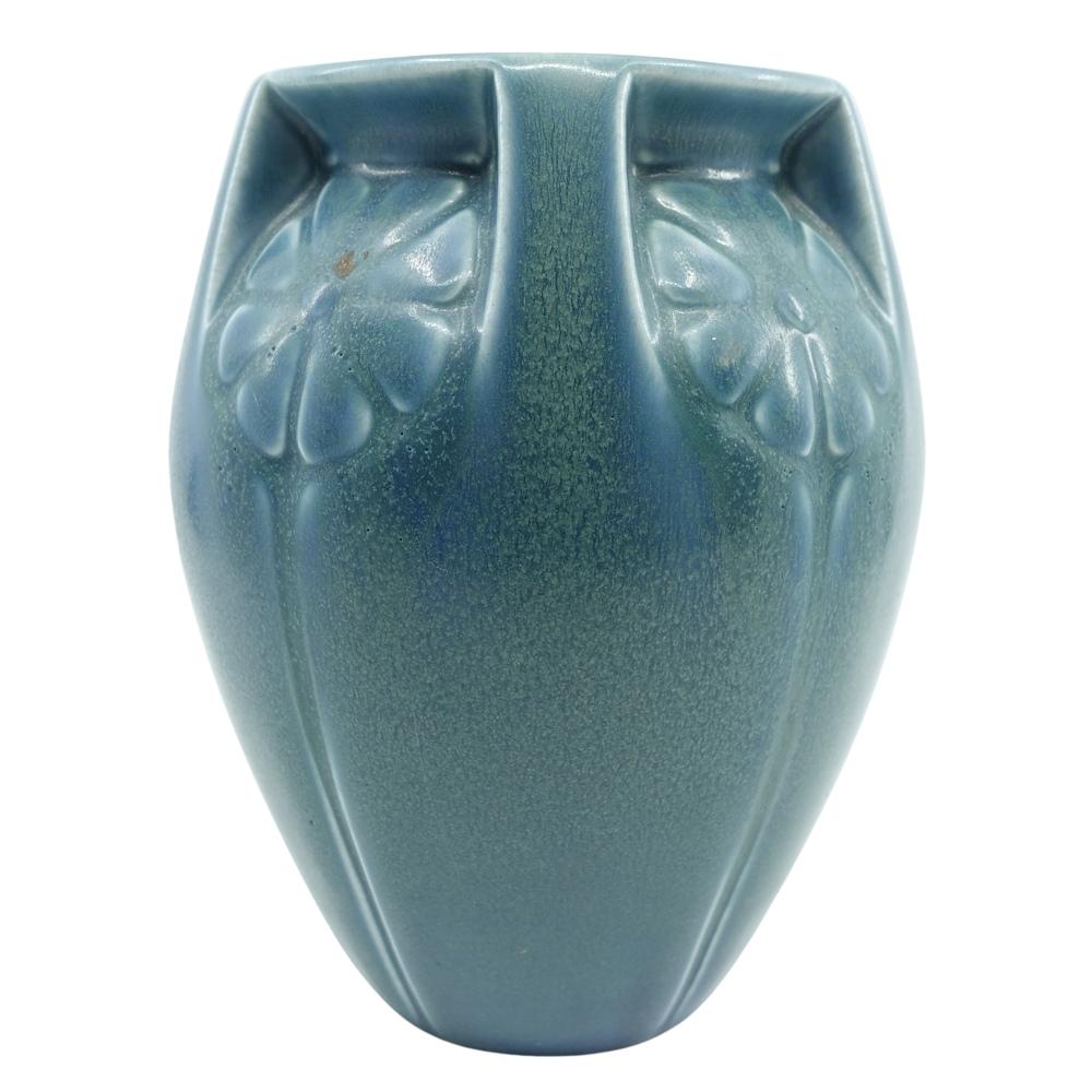 Offering this substantial hand glazed Rookwood pottery vase featuring an incised stylized floral design within five buttresses. This vase is has a gorgeous medium to dark green-blue glaze with lighter colored threading and lovely glaze drips. Vase