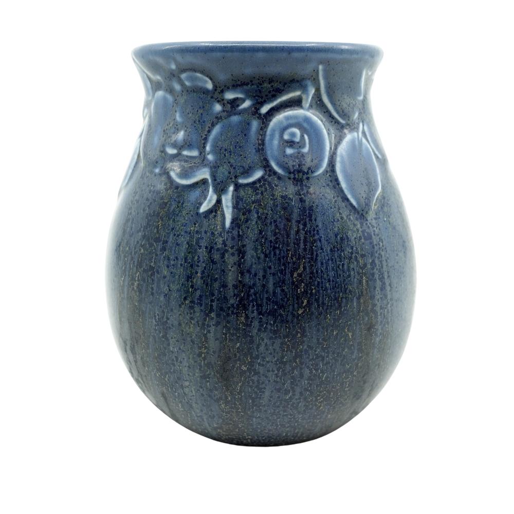 Offering this hand glazed Rookwood pottery vase featuring a an incised stylized berry and foliage design on a bulbous cylindrical body. This vase is has a gorgeous dark blue glaze with darker colored striping. Vase is marked by the impressed 