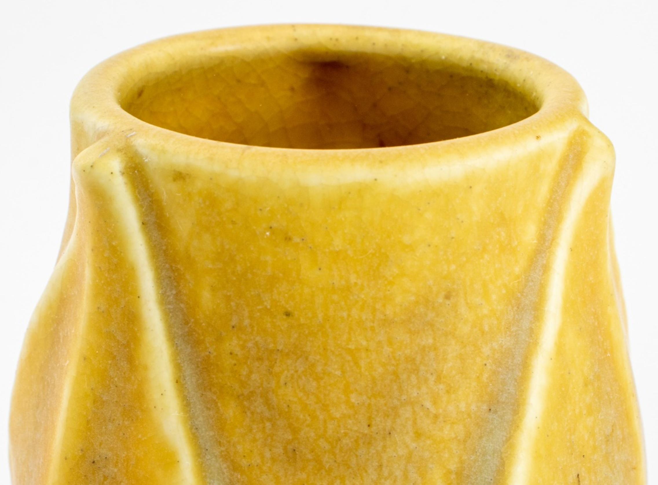 Rookwood Art Pottery vase, with impressed marks for Rookwood, date marks for 1917, and model number 2381, an ochre glazed elongated floriform with petals. 

Dimensions: 6.75