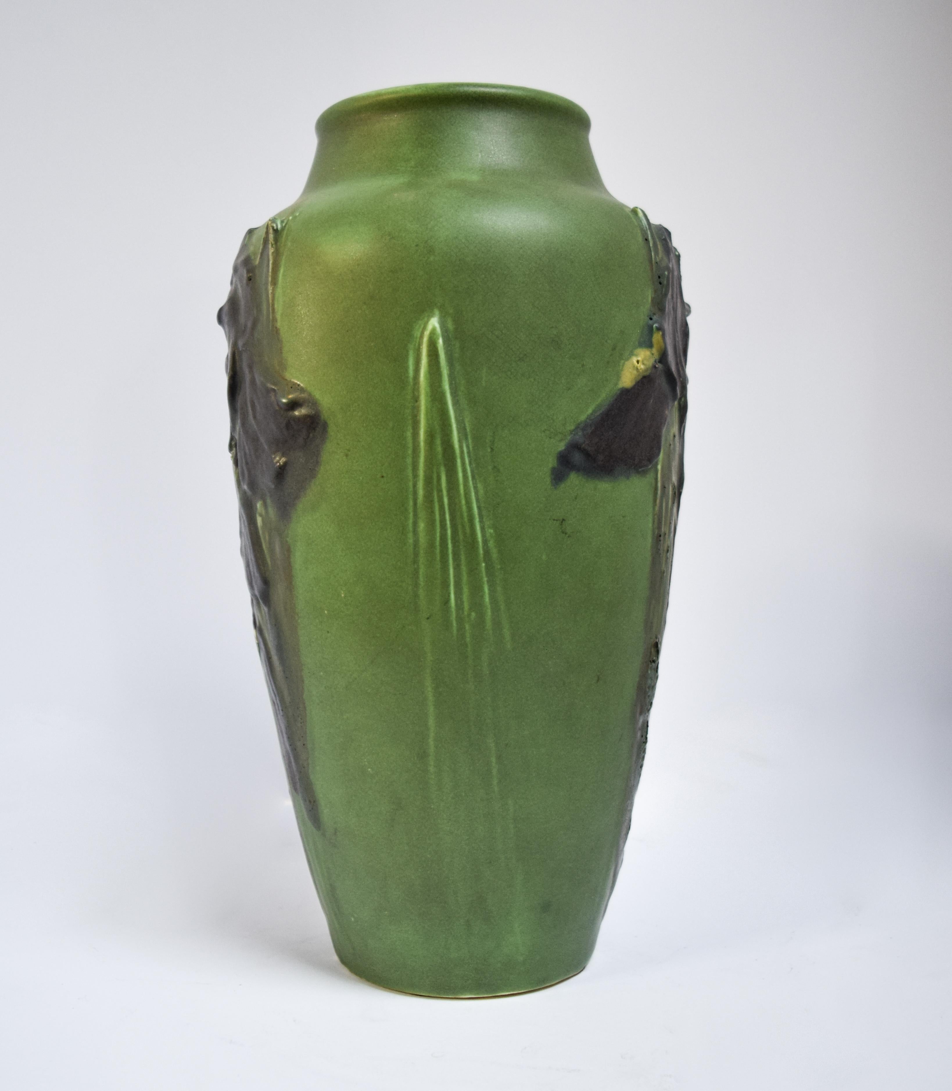 A staple of American pottery, the work of Albert Pons was a major influence on the Rookwood Pottery Company at the turn of the century during the Arts & Crafts movement. Crafted in 1905, this vase is a fabulous green adorned with purple iris’ in