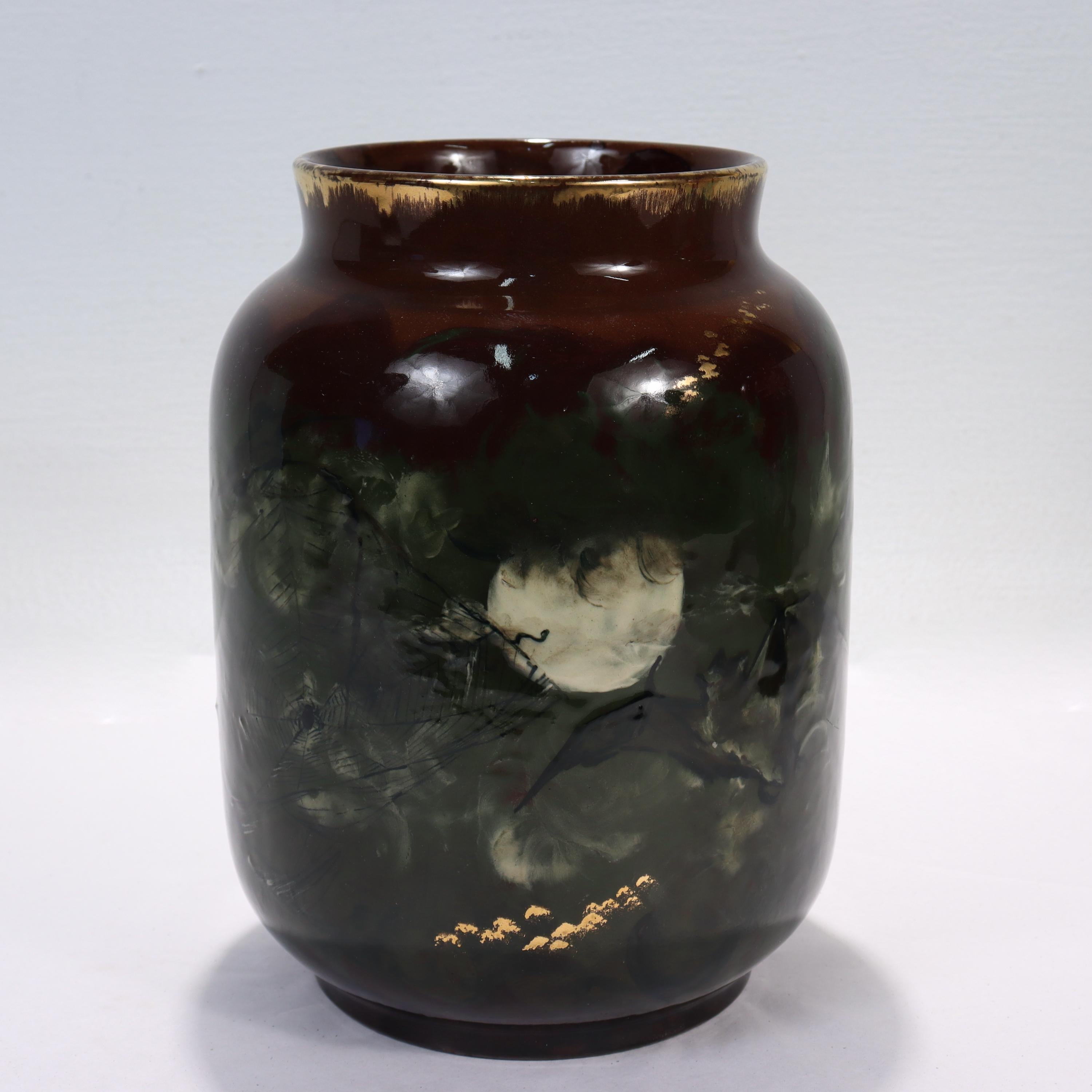 A fine antique Aesthetic Period Rookwood pottery vase.

Decorated with a spider on its web under the moon, bats, & clouds on a brown ground with gilt highlights with a Limoges glaze.

By Albert R. Valentin.

Fully marked and signed in mongram