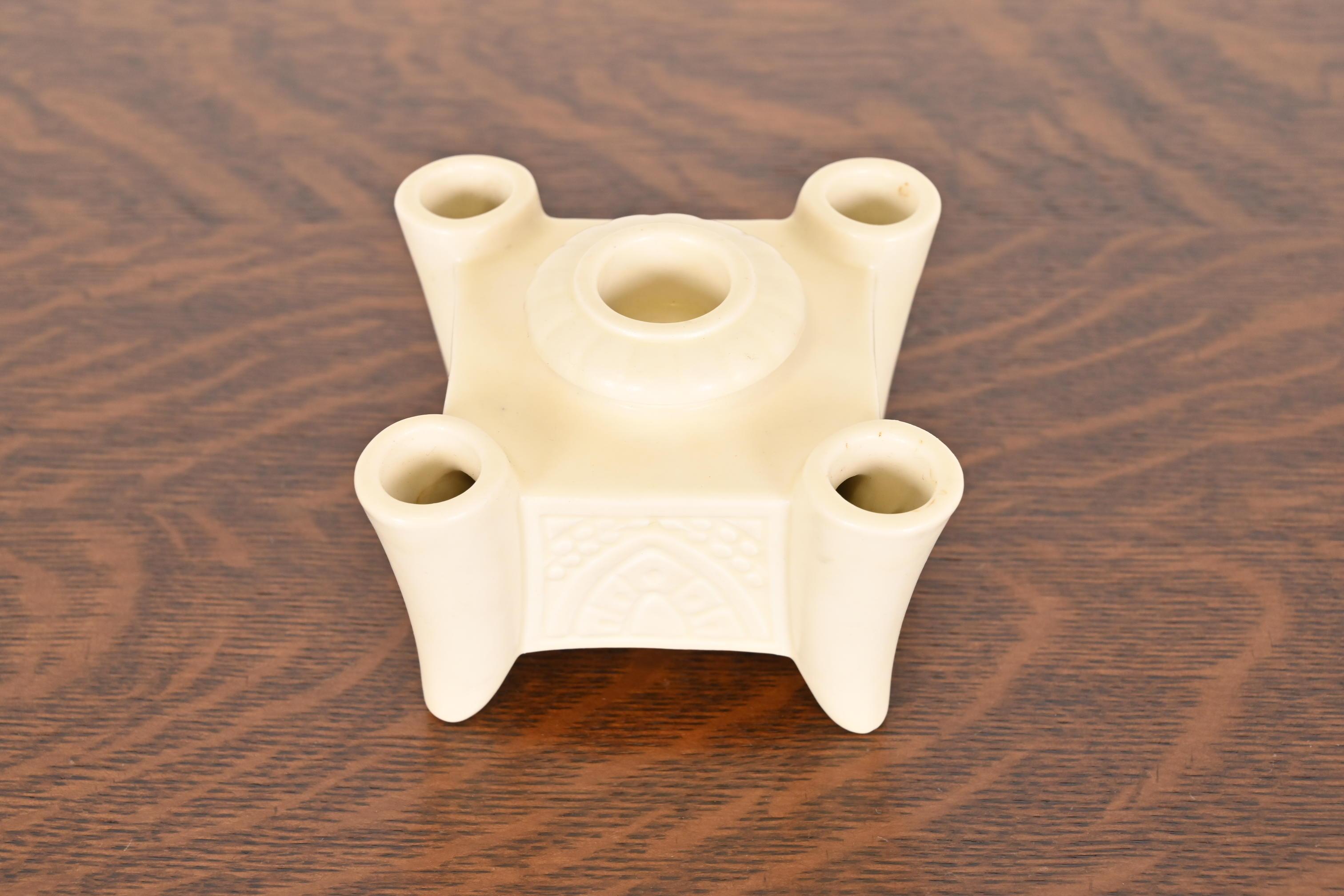A gorgeous Arts & Crafts period glazed art pottery candlestick holder

By Rookwood Pottery

USA, 1934

Glazed ceramic in a beautiful cream color.

Measures: 4