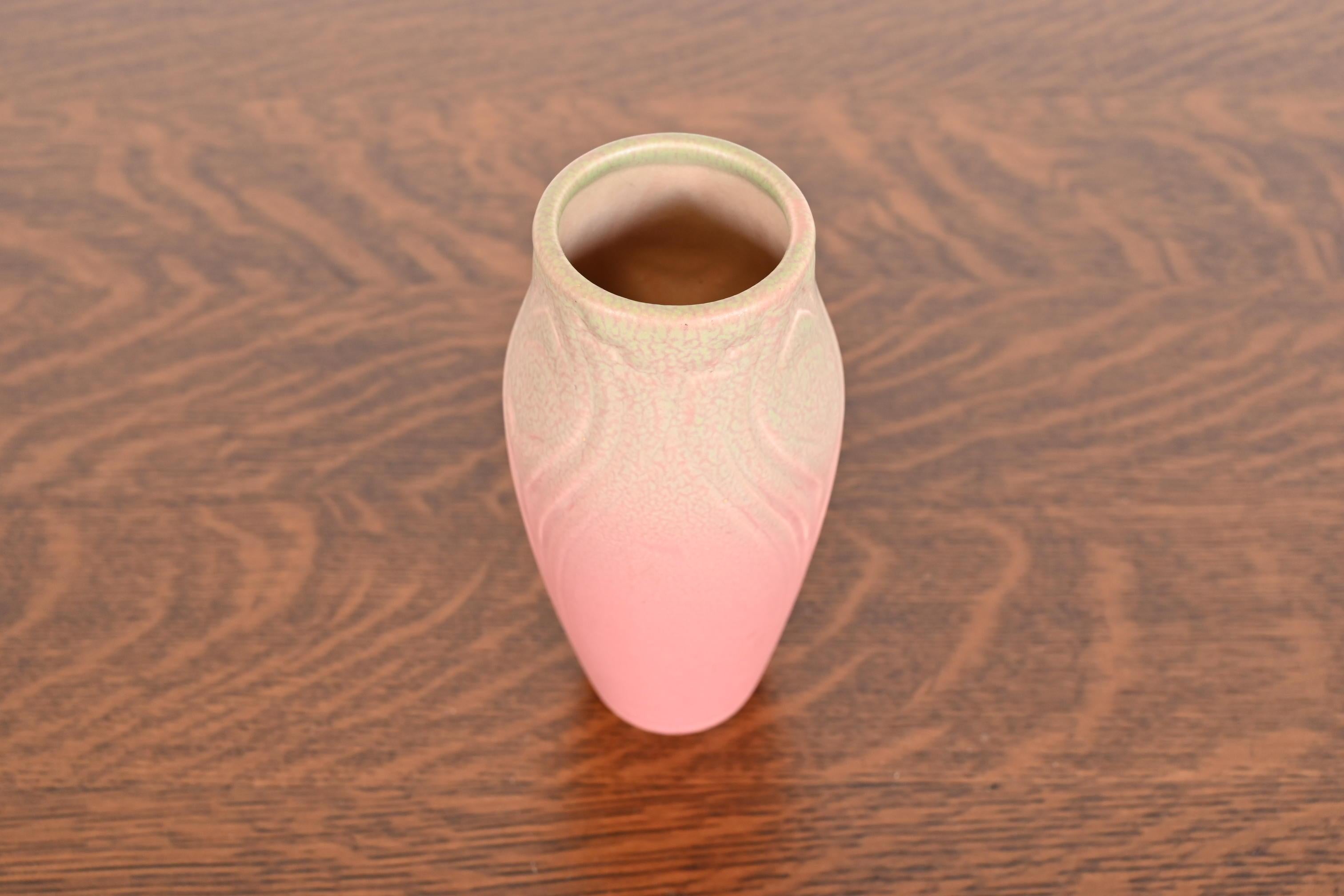A gorgeous Arts & Crafts period glazed art pottery vase with floral decoration

By Rookwood Pottery

USA, 1921

Glazed ceramic in a beautiful light pink color with green accents.

Measures: 3