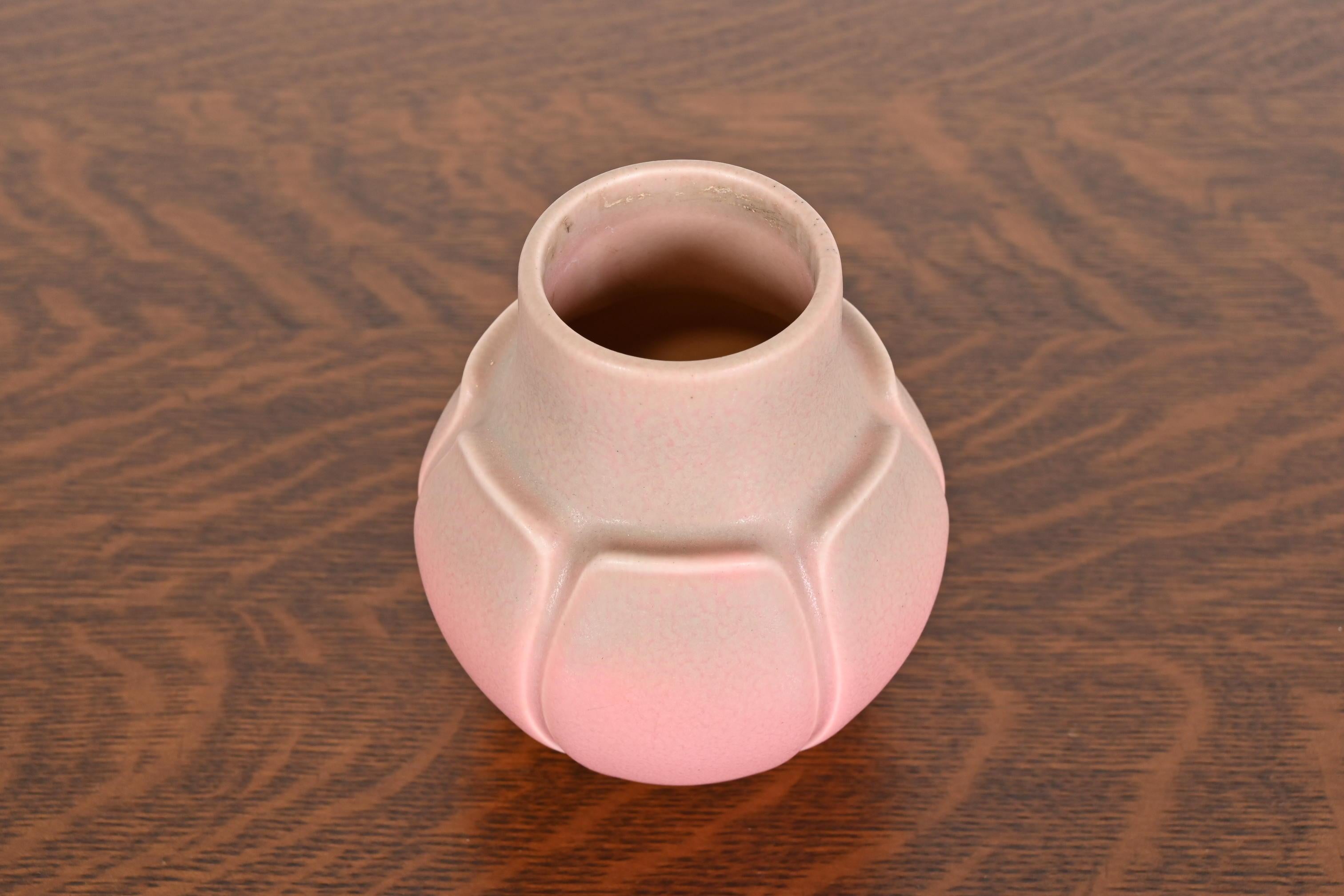 A gorgeous Arts & Crafts period glazed art pottery vase

By Rookwood Pottery

USA, 1927

Glazed ceramic in a beautiful light pink color with green accents.

Measures: 4
