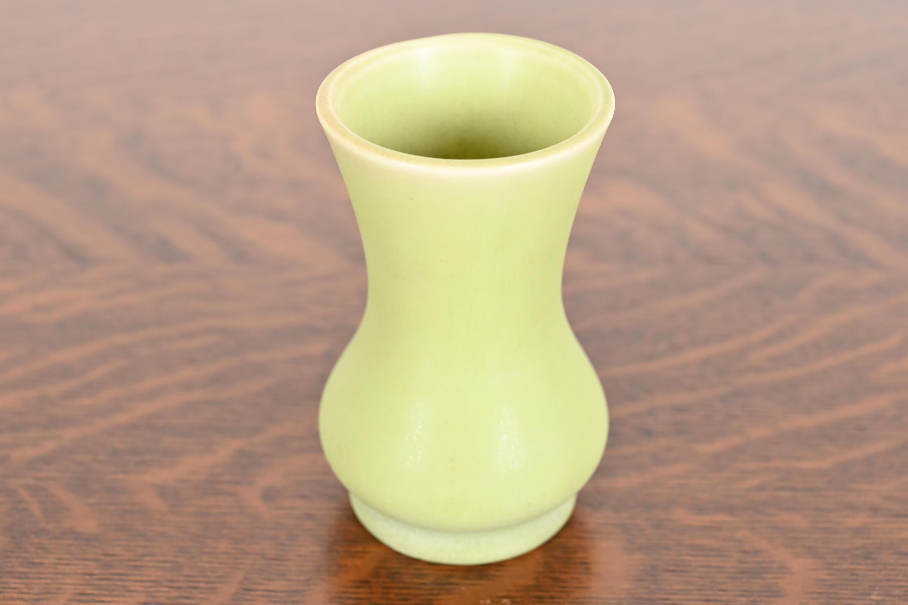 A gorgeous Arts & Crafts period petite glazed art pottery vase

By Rookwood Pottery

USA, 1930

Glazed ceramic in a beautiful light green color.

Measures: 2.5