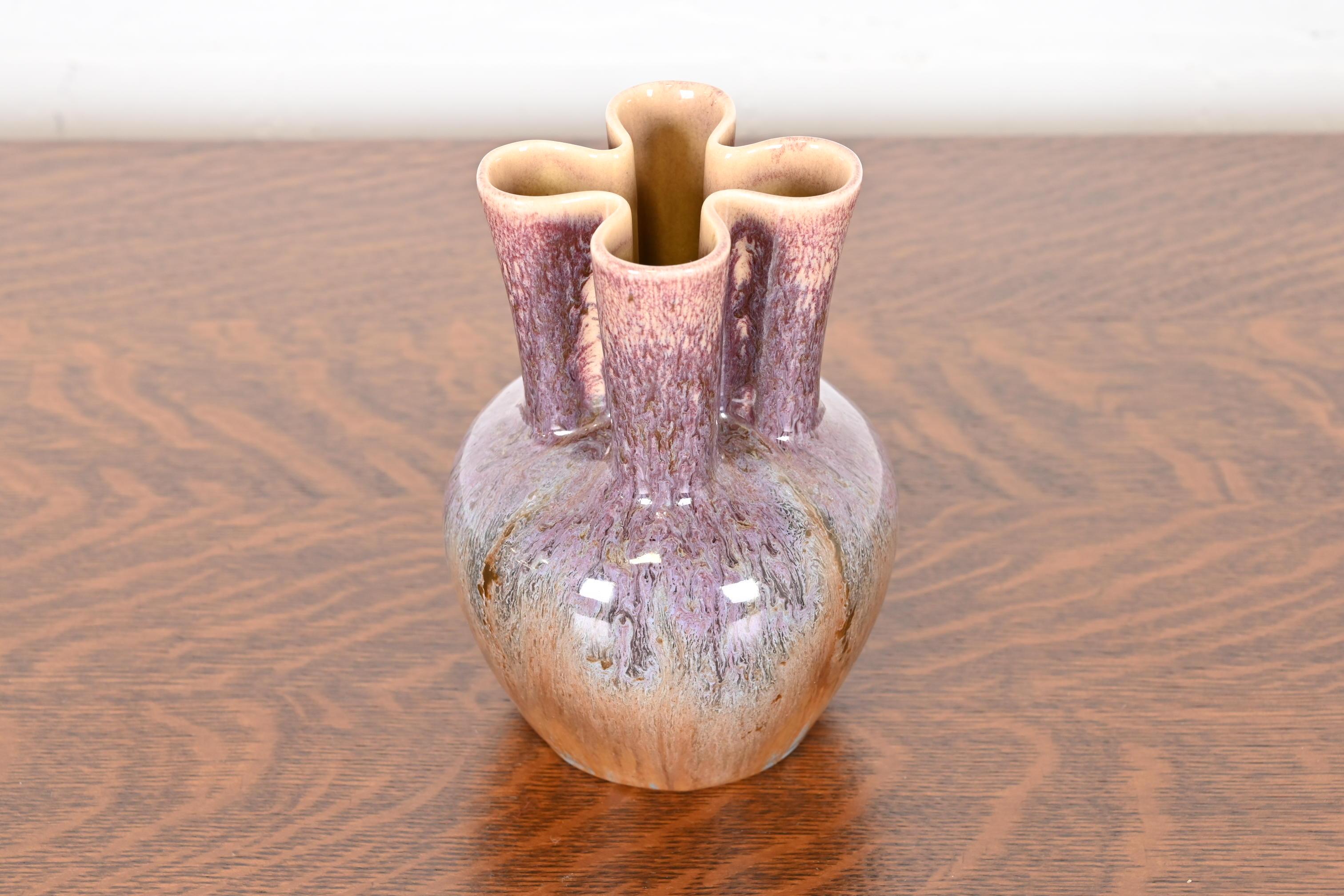 A gorgeous Arts & Crafts period glazed ceramic art pottery vase

By Rookwood Pottery

USA, 1951

Glazed ceramic combining orange, turqouise, purple, and pink tones with cream interior.

Measures: 5