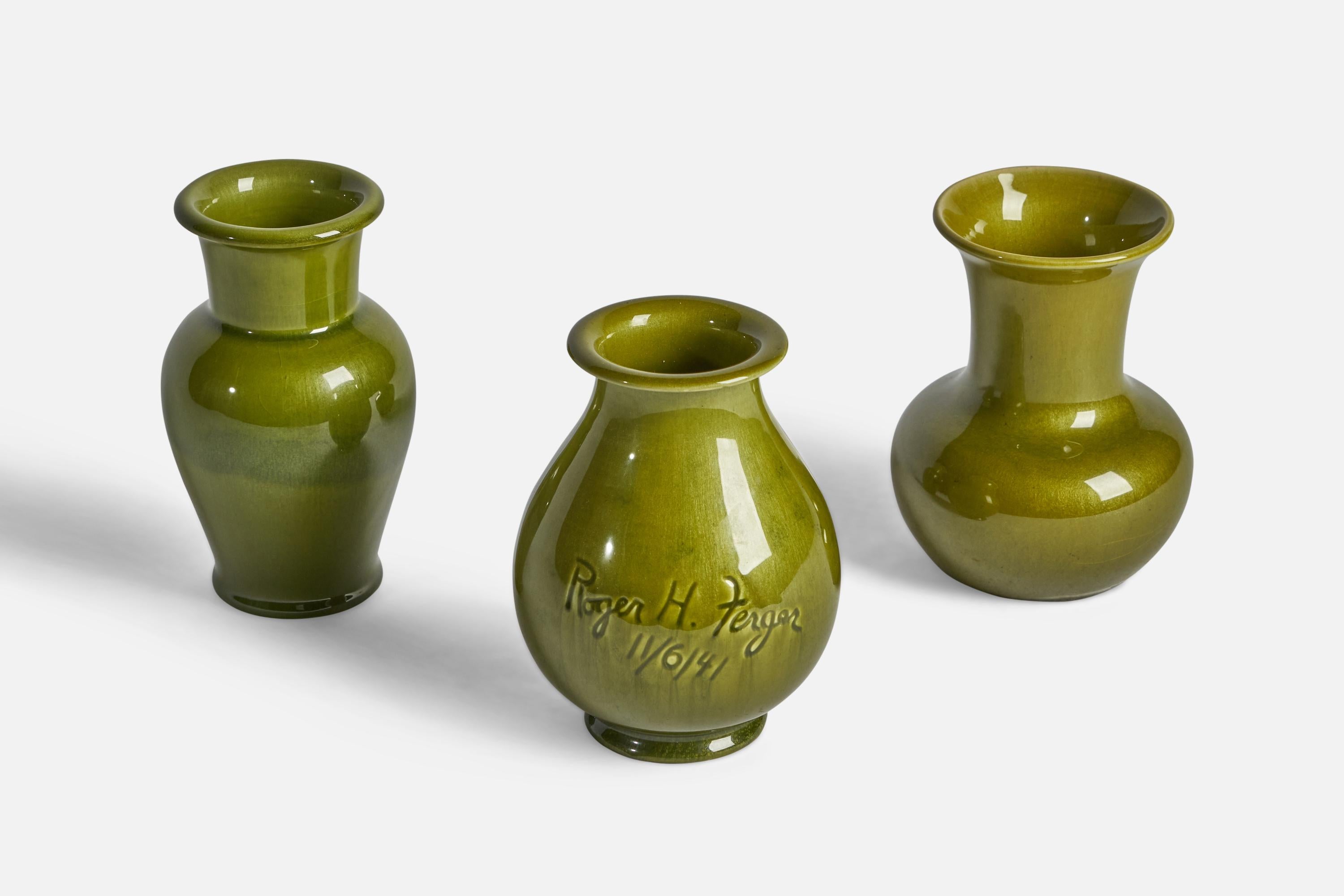A set of three green-glazed porcelain vases designed and produced by Rookwood Pottery and Kenton Hills Porcelains respectively. One vase signed Roger H. Ferger and dated 1941.

Overall Dimensions (inches): 5.75” H x 4.5” Diameter
Overall Dimensions