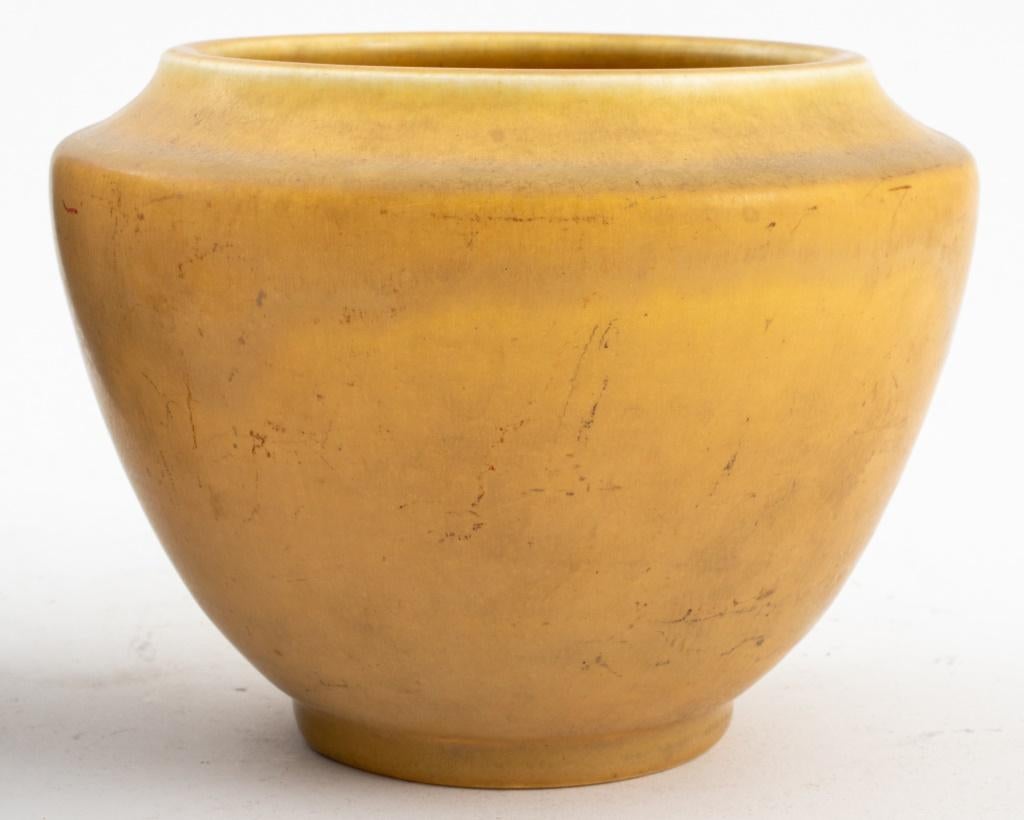 Three pieces of Rookwood Art Pottery from the first half of the twentieth century and comprising one blue glazed vase, marked to underside for 1934, one mustard yellow glazed bowl, marked to underside for 1927, and one antique cappuccino brown