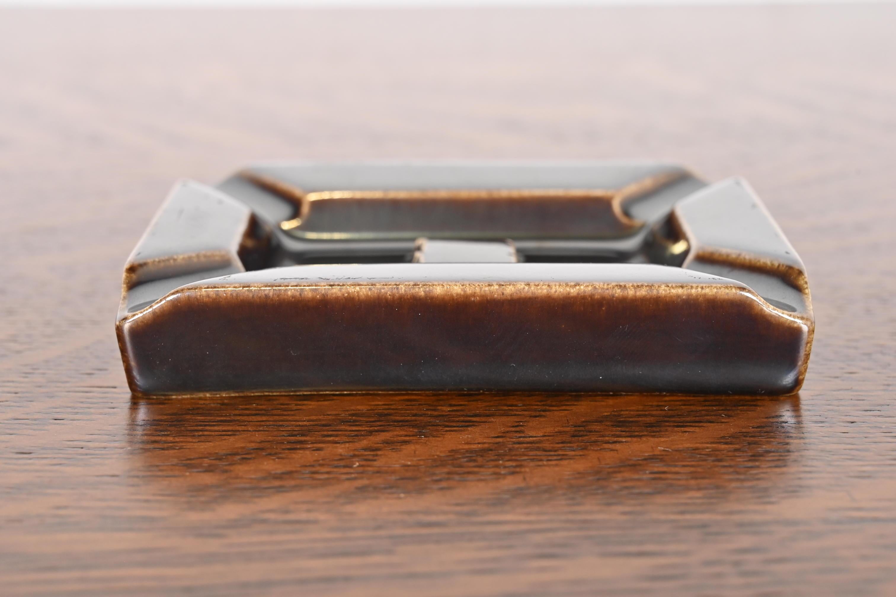 A gorgeous Mid-Century Modern glazed art pottery ashtray or catchall

By Rookwood Pottery

USA, 1954

Glazed ceramic in a handsome deep brown color.

Measures: 4.25