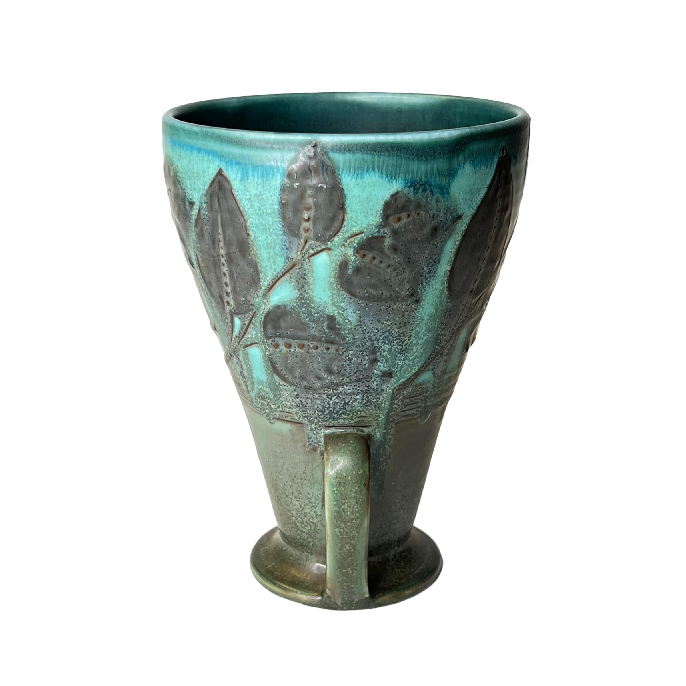 Our handled vase with mottled blue/green glaze was designed by William Ernst Hentschel (1882-1962) for Rookwood and produced in 1929. Underside with the mark of the firm and date code for 1929, plus the monogram of the artist.