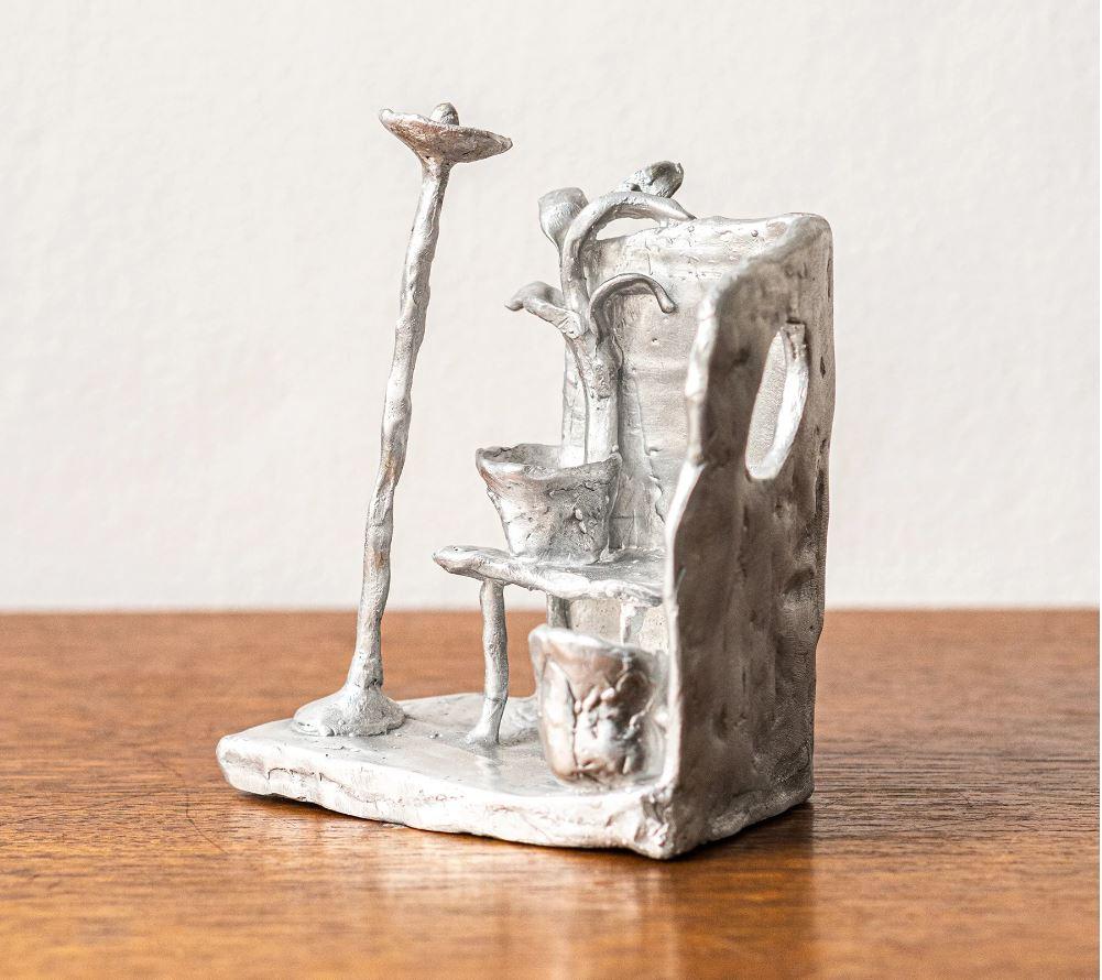 Cast Handmade Aluminium cast sculptural candle holder depicting 