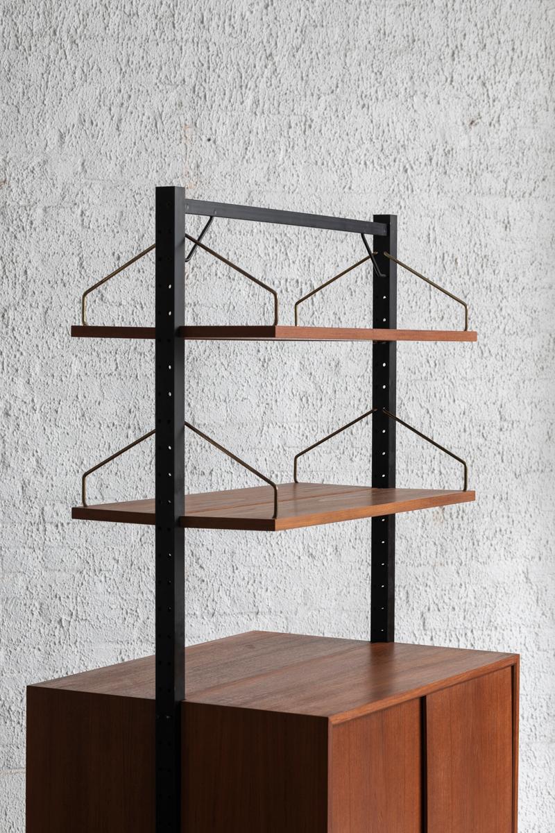 Room divider designed by Poul Cadovius and produced in Denmark around 1960. This set features two black lacquered steel supports and a large cabinet with 2 shelves on each side. In good condition with some wear as shown in the pictures.

H: 190