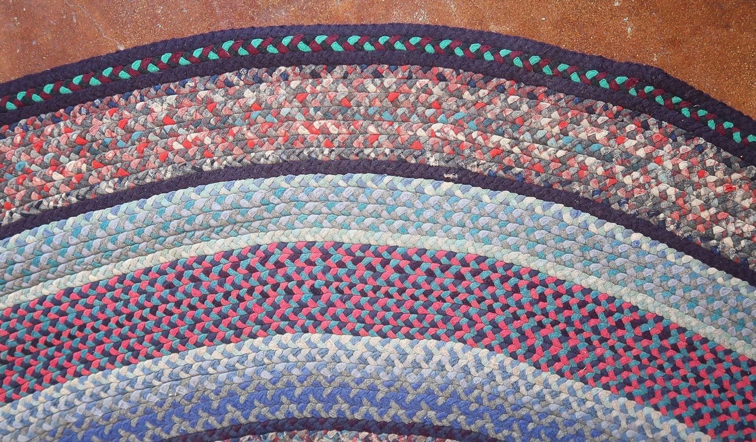 This colorful, room-size, oval, hand-braided rug was found here in Maine where braiding rugs with wool scraps was a traditional home craft, as it was in many rural areas across the country.The condition is pristine and fantastic with country style