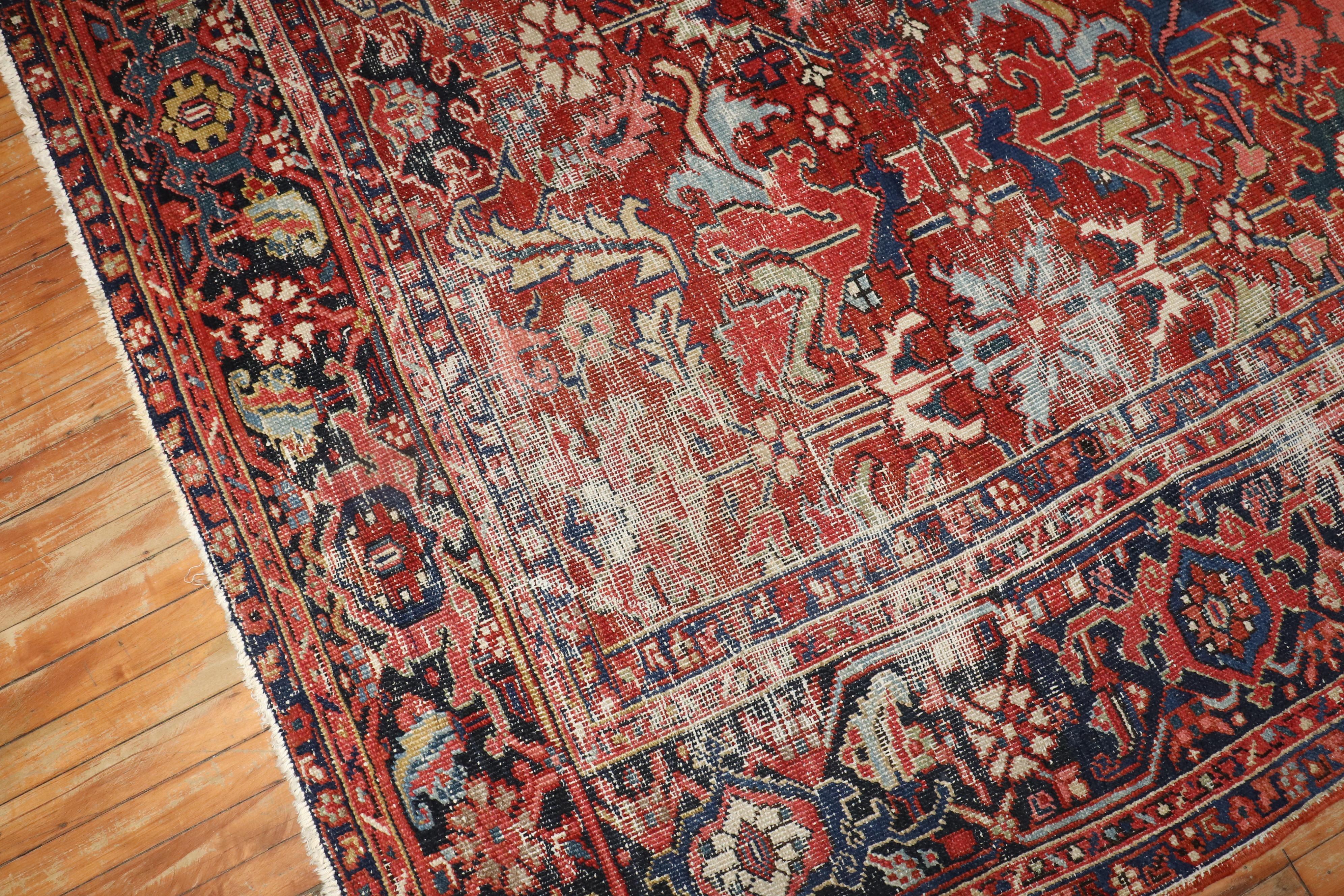 An early 20th century Persian Heriz room distressed rug.

Measures: 7'8'' x 9'10''.