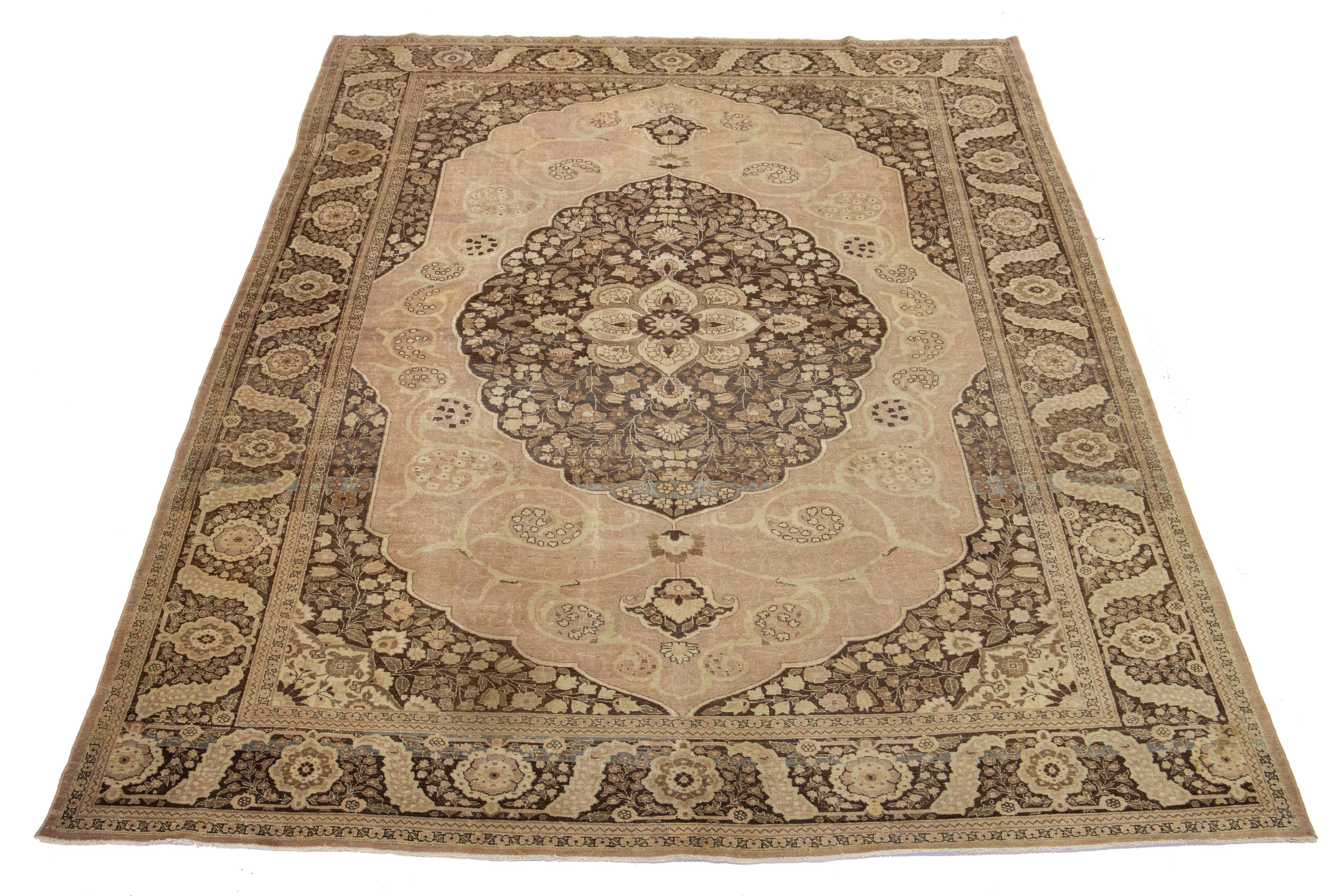 Ancien tapis persan Tabriz des années 1930 avec une bordure beige, des détails gris et un champ brun présentant un motif géométrique sur toute la surface.

Ce tapis mesure 9'10'' x 13'.

Nos tapis sont nettoyés professionnellement avant d'être
