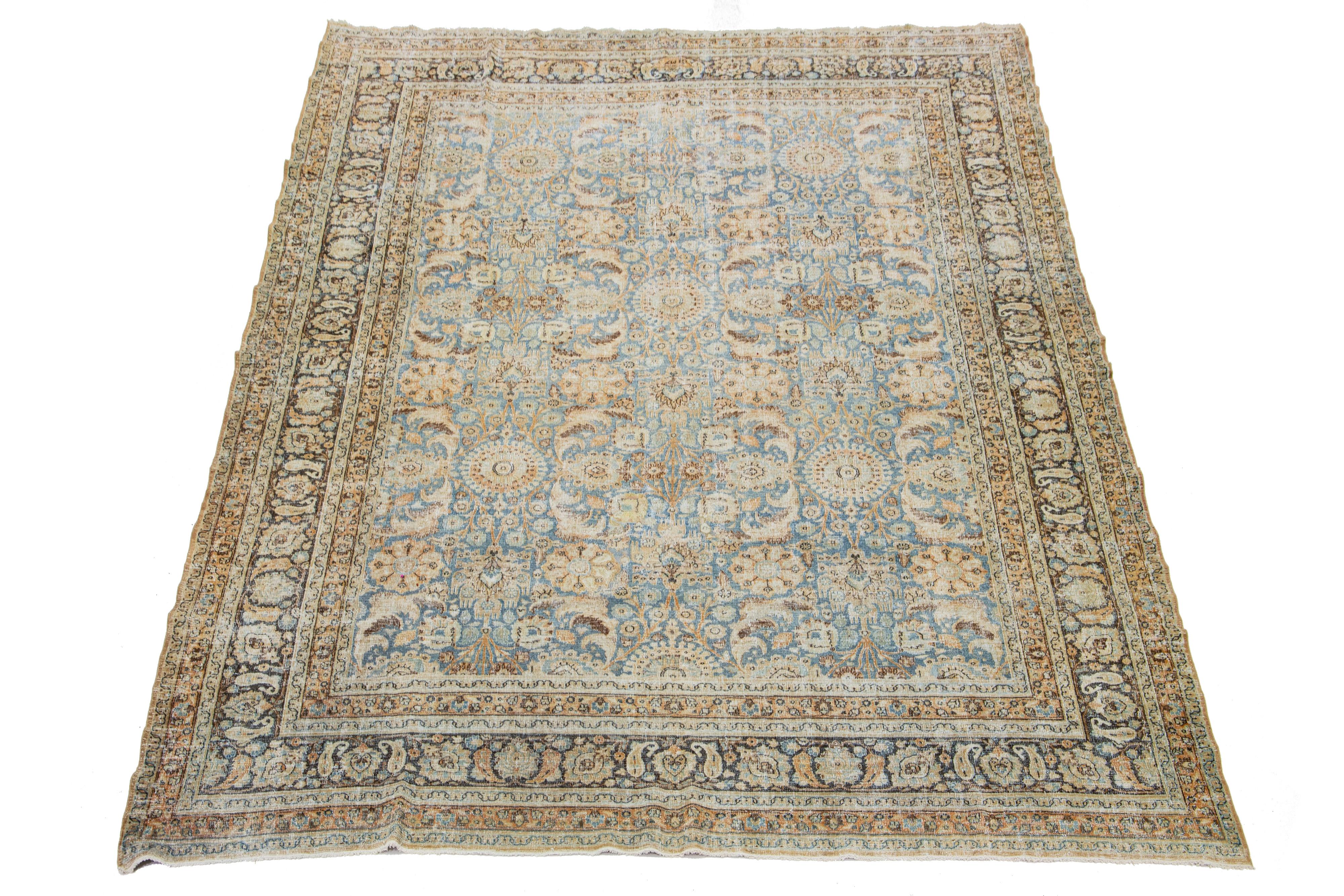 This Persian Tabriz wool rug, handcrafted, showcases a traditional floral pattern. The contrast between the blue backdrop and the peach and brown emphasizes the design.

This rug measures 10' X 13'4