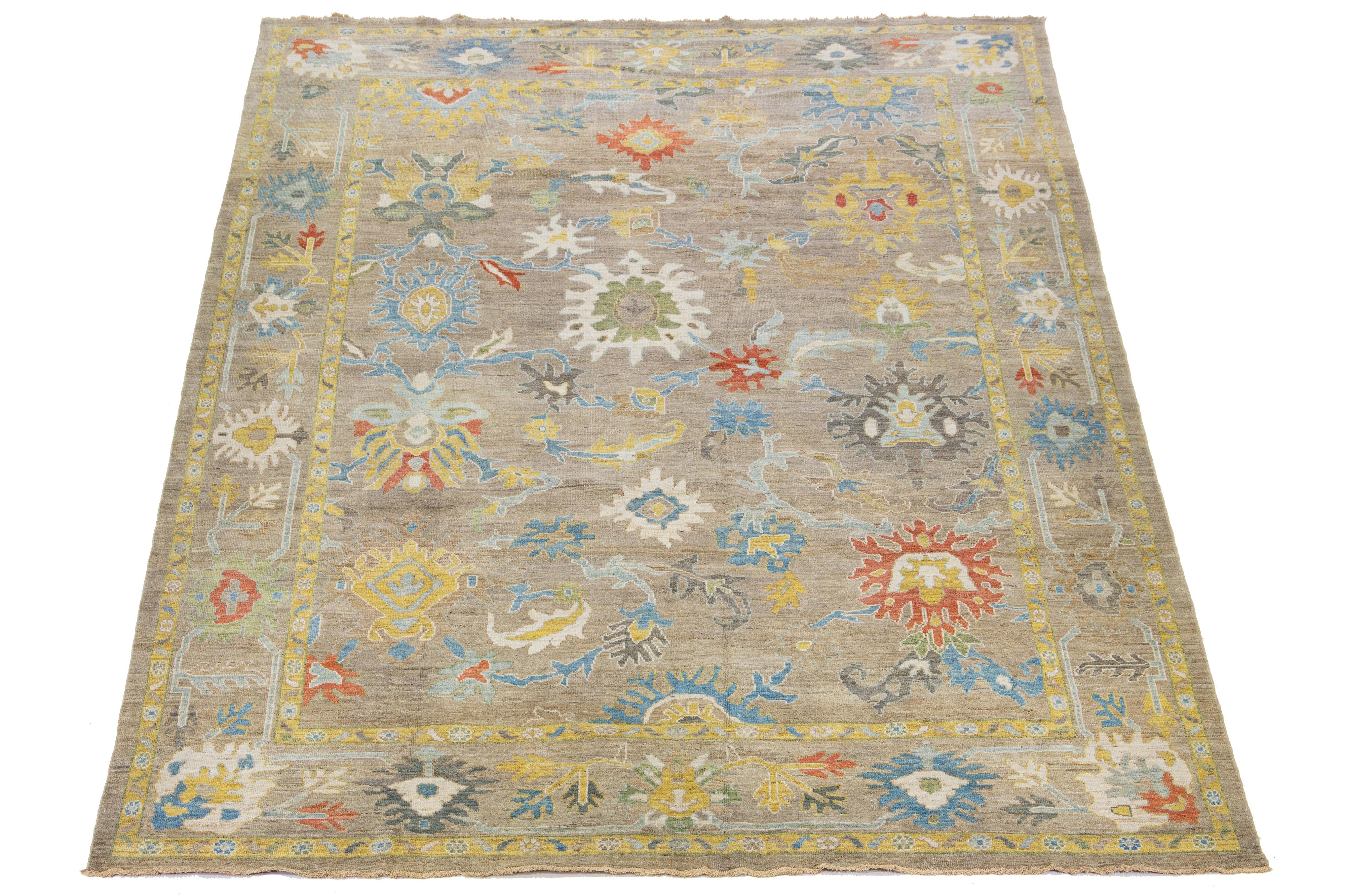 Beautiful modern Sultanabad hand-knotted wool rug with a light brown field. This Sultanabad rug has a designed frame and multicolor accents in a gorgeous classic floral pattern.

This rug measures 10'3