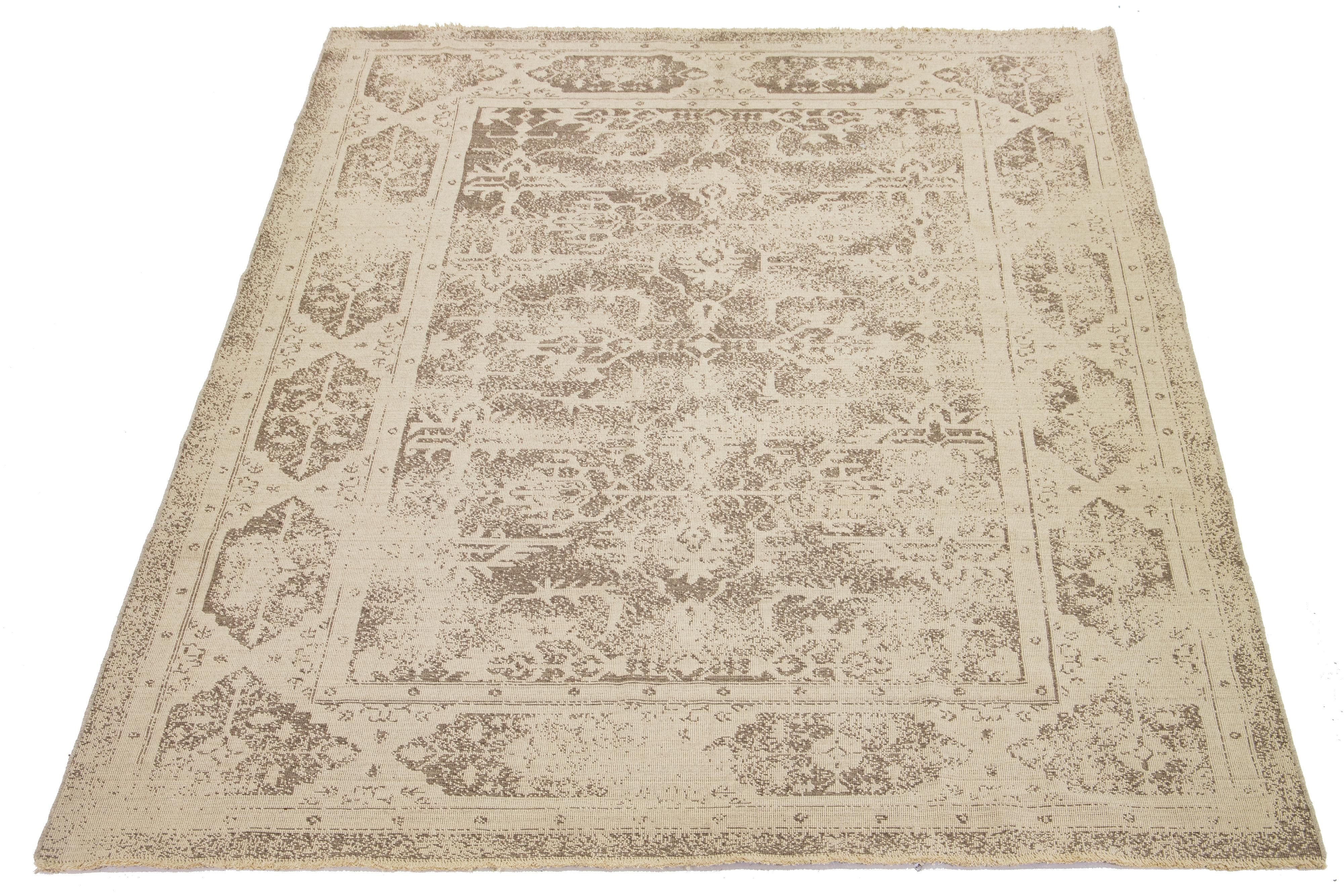 This beige wool rug features a light brown all-over pattern that beautifully complements the background.

This rug measures 9'8