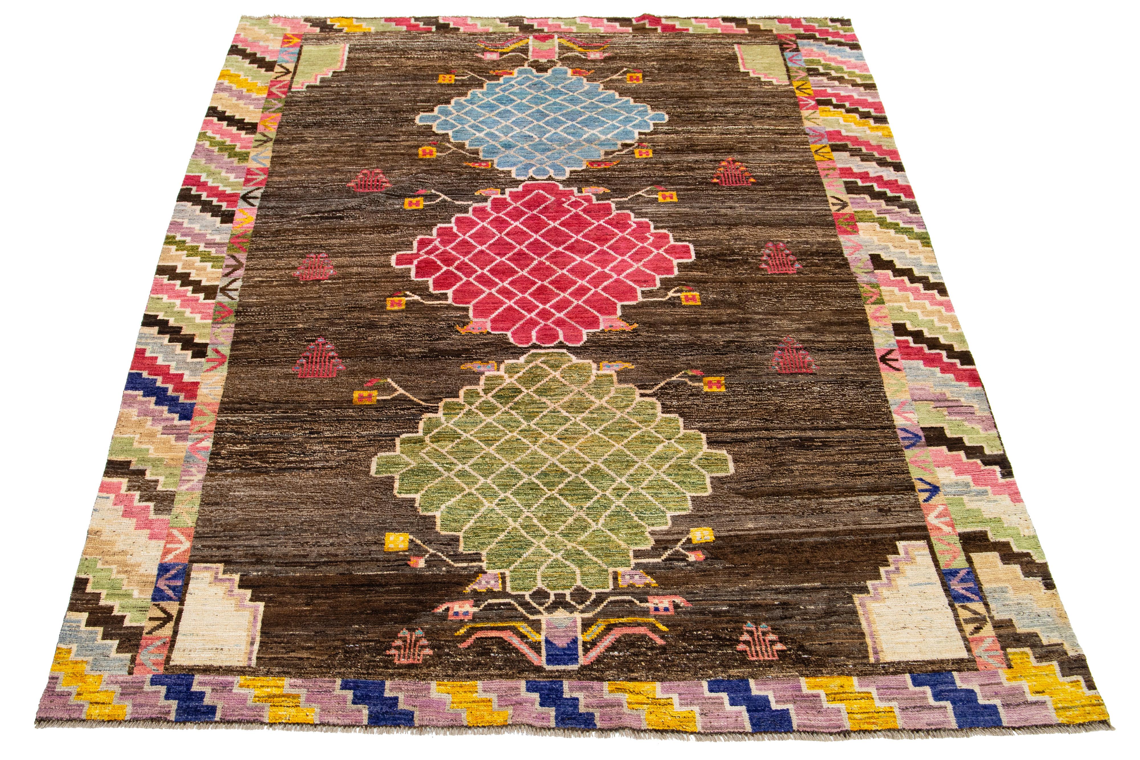 This wool rug showcases a modern take on the Moroccan style, boasting a striking blue and brown color field. It features a captivating all-over pattern in many colors, adding vibrancy to any space.

This rug measures 6'11