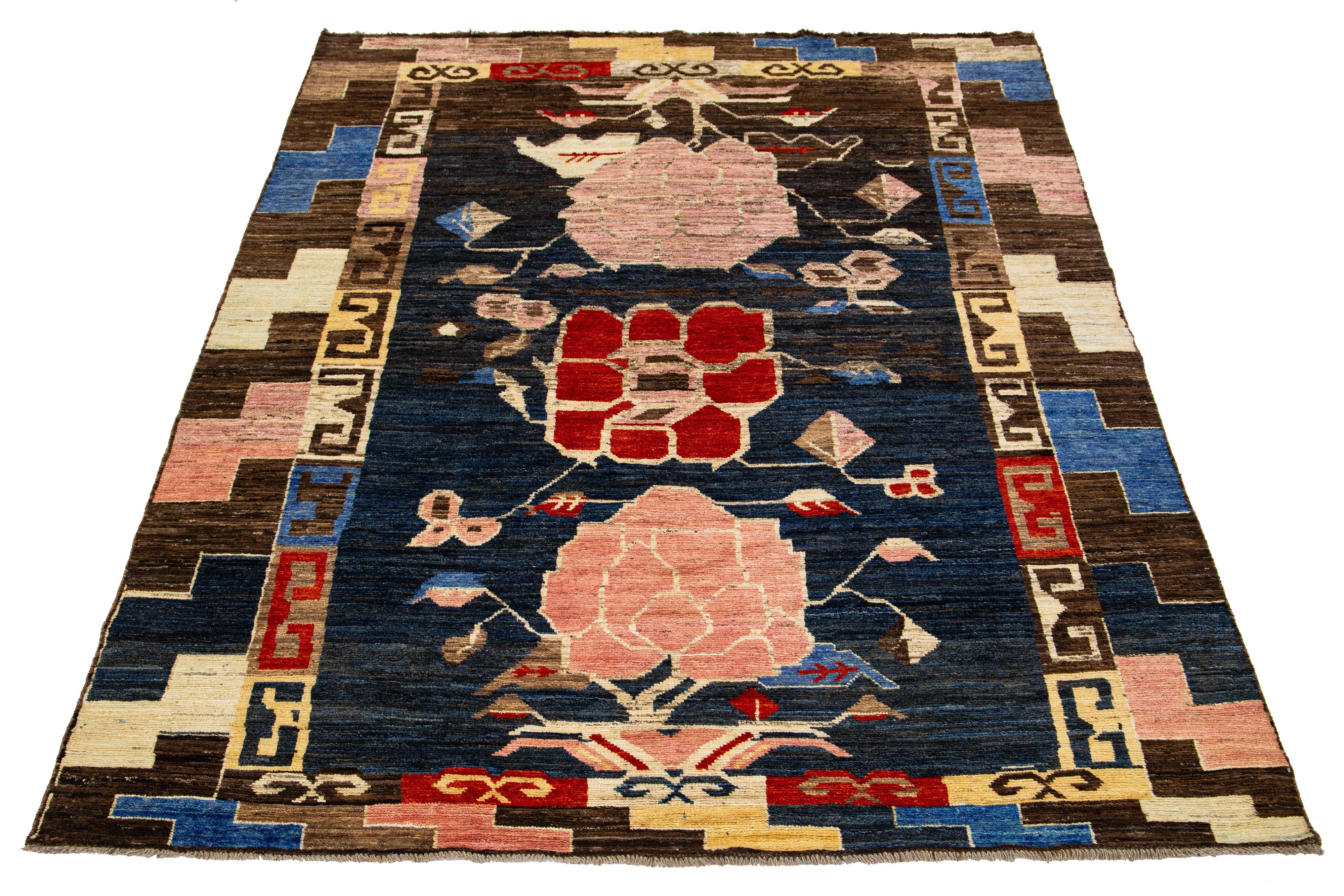 This wool rug showcases a modern take on the Moroccan style, boasting a beautiful navy blue color field. The rug features a captivating Tribal pattern in a multitude of colors, adding vibrancy to any space.

This rug measures 6'11