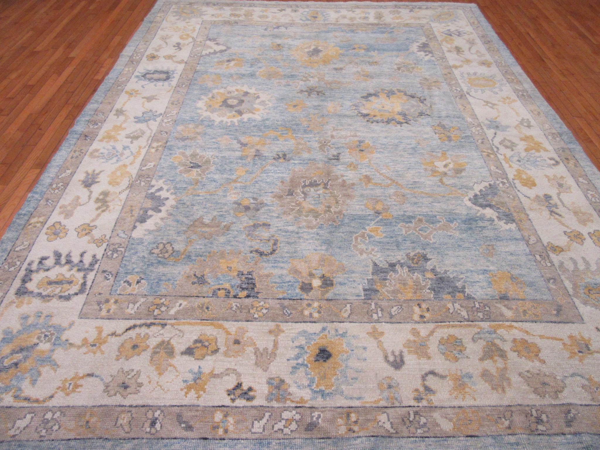 This is a new room size hand knotted Turkish Oushak rug. It is made with all good quality Turkish wool in the spirit of the antique Oushak rugs. It measures 9' 5'' x 12' 6'' a great addition to any room.
