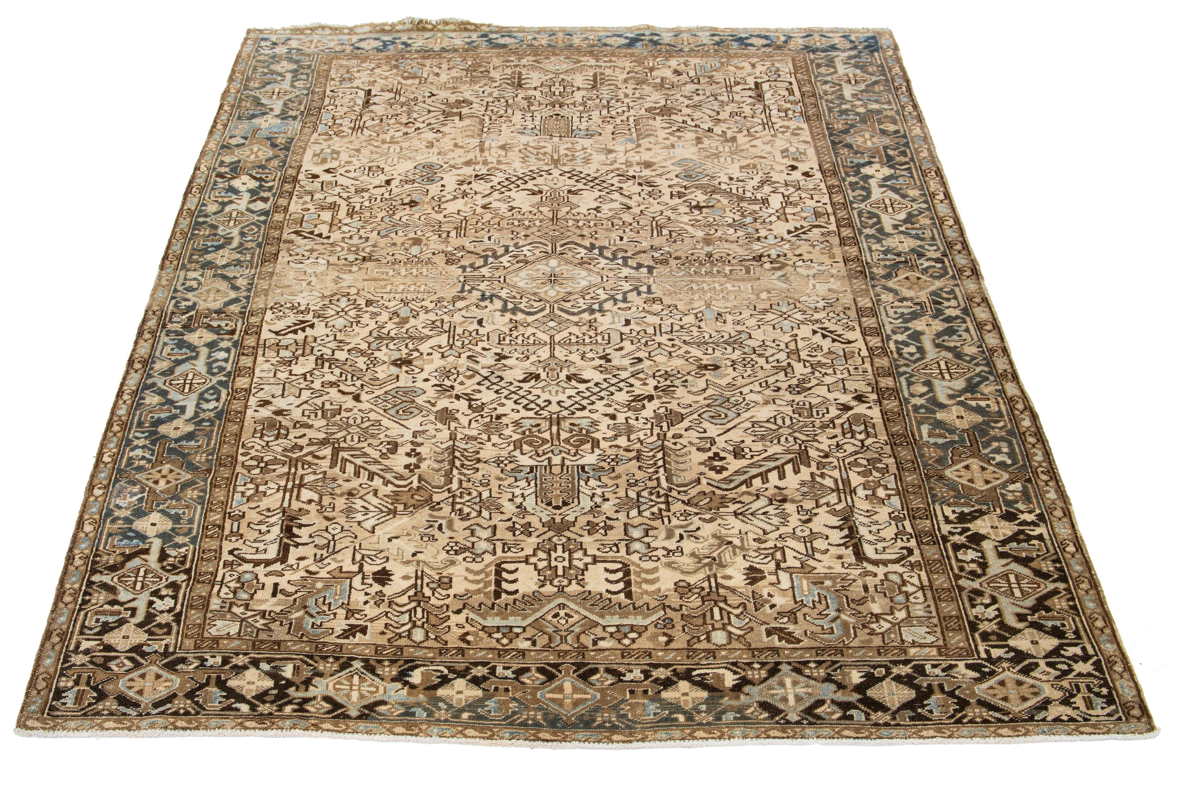 This hand-knotted antique Persian rug, made from wool, features a tan field with an all-over blue and brown pattern.

This rug measures 8'2' x 11'2
