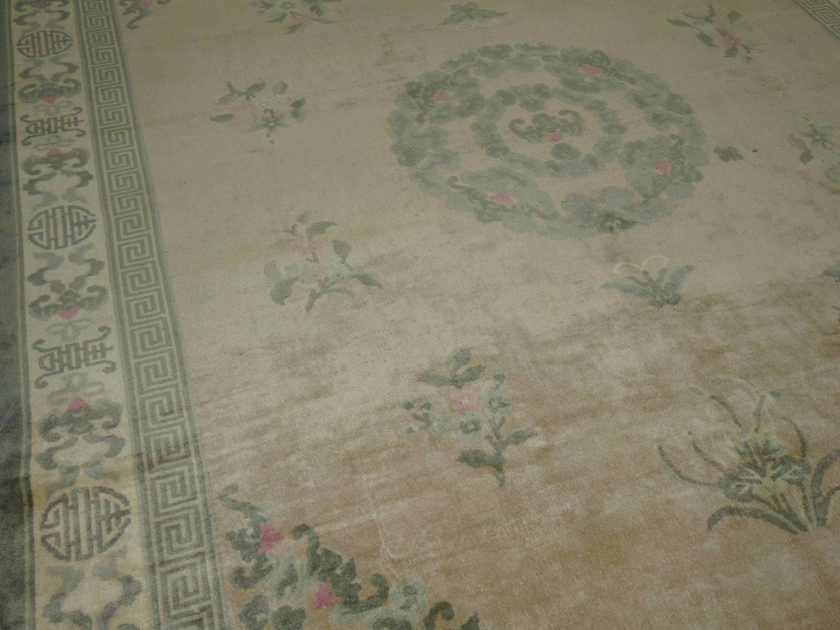A mid-20th-century room-size Chinese rug , beige field, green accent tones. pops of pink pop upas well

Measures: 7'11'' x 10'1''.