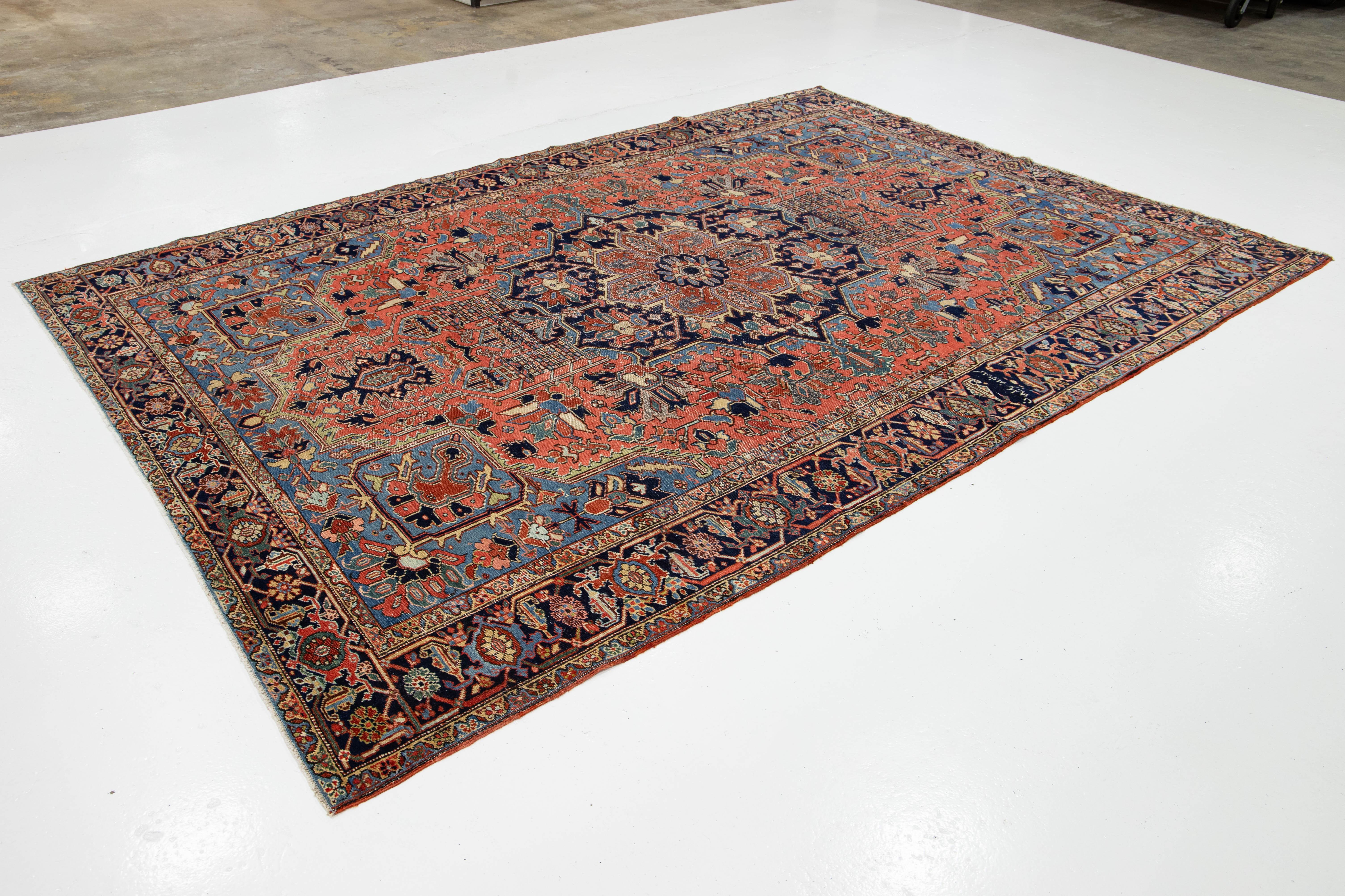Hand-Knotted Room-Sized Antique Persian Heriz Rug in Red Wool Featuring a Medalllion Motif For Sale