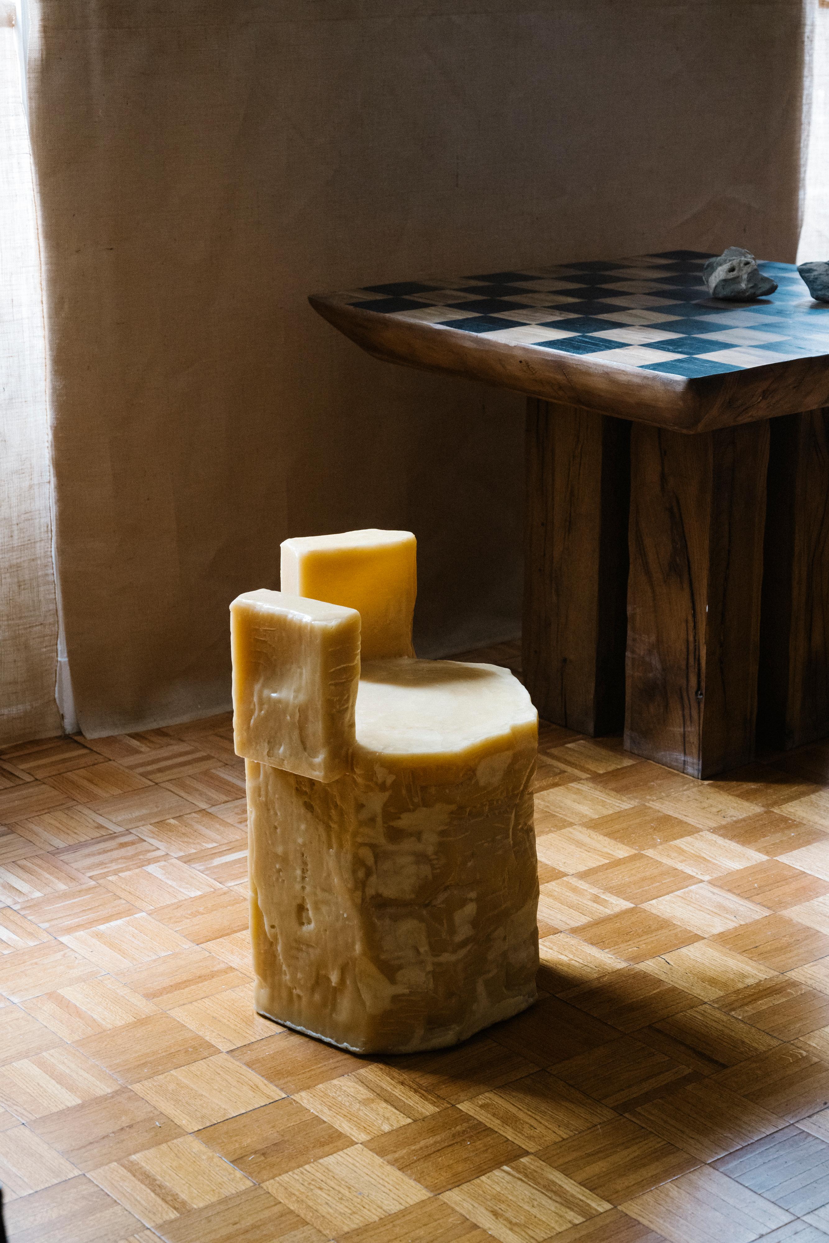 This one-of-a-kind sculptural beeswax chair with sides is designed by Rooms Studio in collaboration with Shotiko Aptsiauri and was produced in Tbilisi, Georgia. The molded, beeswax sculpture, which can be interpreted as a stool, seat, side table or
