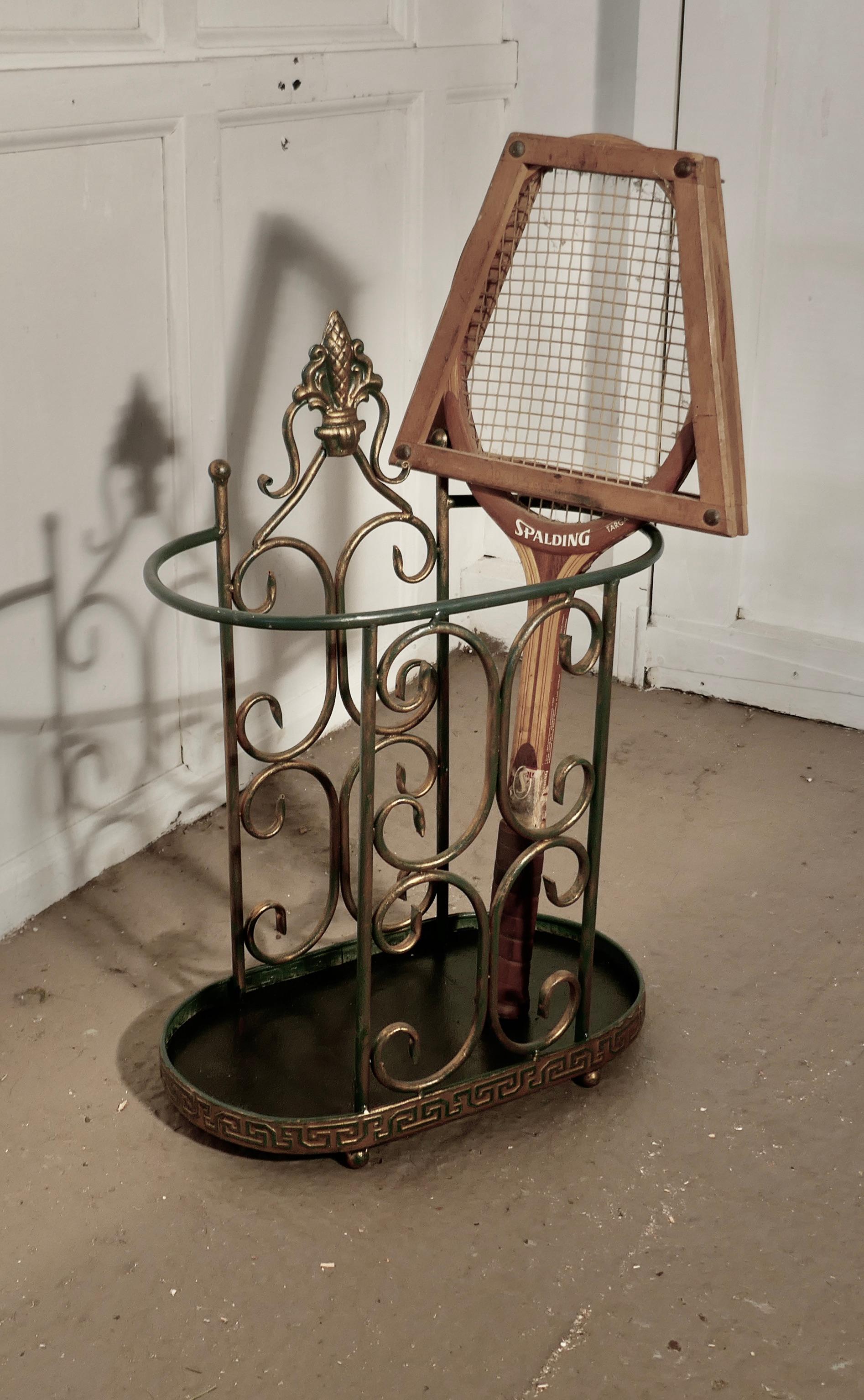 Roomy half round wirework stick stand or umbrella stand

A charming piece, and it has a very unusual half moon shape, the stand has green and gilt painted decoration and will hold both walking sticks and umbrellas
The stand is 23” high, 16” wide