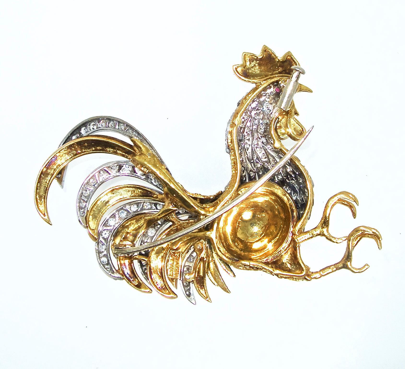 The rooster is 18K white and yellow gold, with 130 diamonds weighing approximately 1 ct and accented with enamel.  Mr. rooster's eyes are small natural rubies.  He is 2.75 inches long.