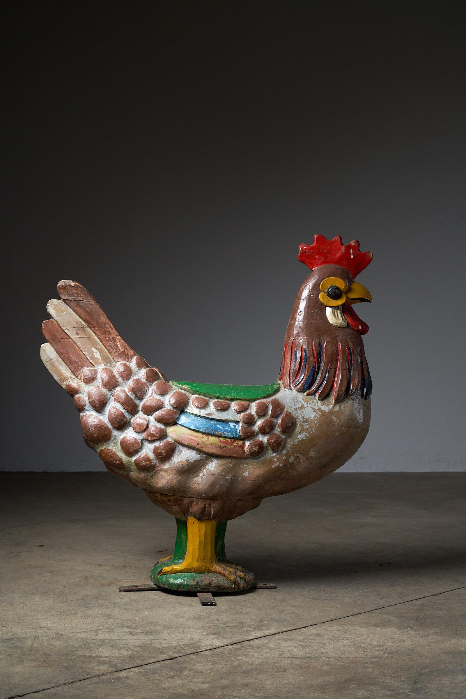 Behold the charm of this antique carousel figure featuring a beautifully carved rooster. Crafted from wood and mounted on a sturdy metal base, this vintage piece adds a touch of rustic elegance. The vibrant colors and detailed carving make it a