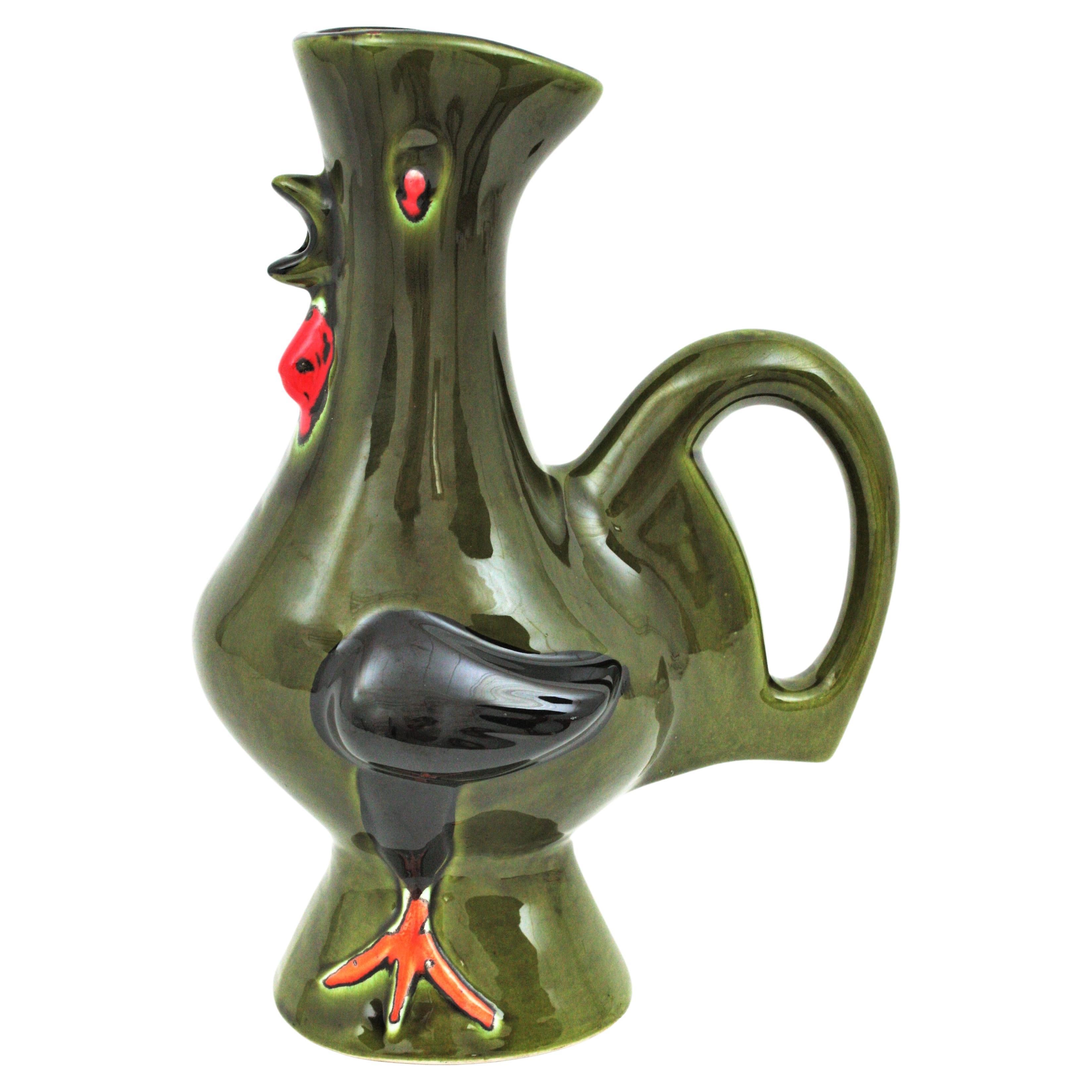 Eye-catching green Majolica ceramic rooster jug / pitcher, France, 1950s.
Handcrafted in green glazed ceramic with red, black and orange accents.
A cool accent to any kitchen or to be user as serving pitcher. Lovely as a part of a ceramics
