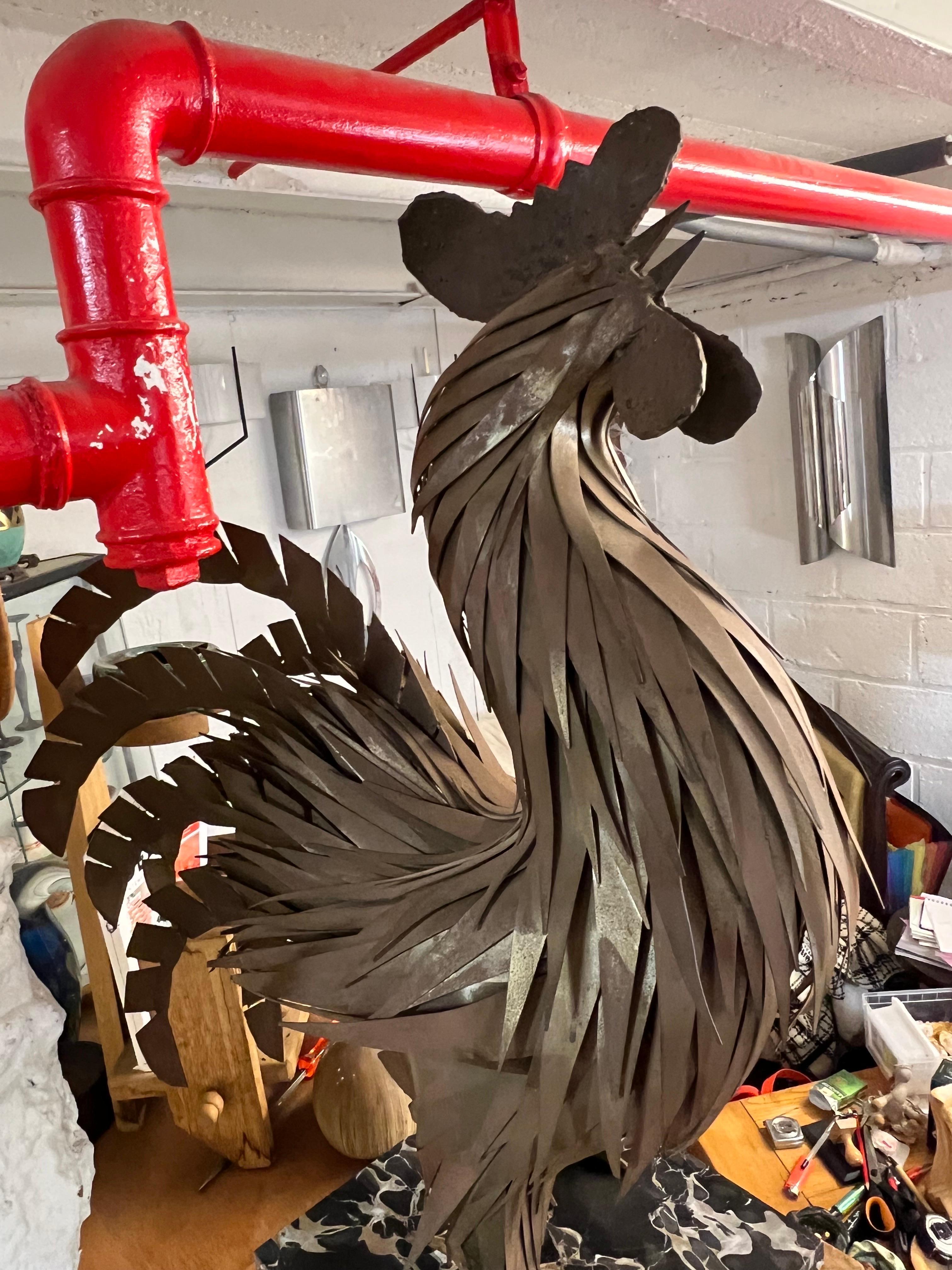 A rooster by a contemporary artist in cut and welded iron.