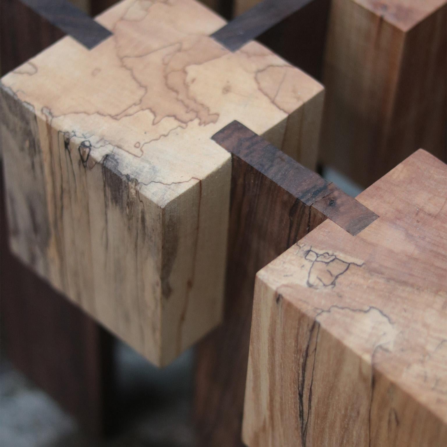The Rooted coffee table stands strong, made from spalted maple and walnut. We use dado joints,
joining woods in a way that marries strength and beauty. Each piece speaks its own truth,
showing flaws that draw the eye. The table is not just