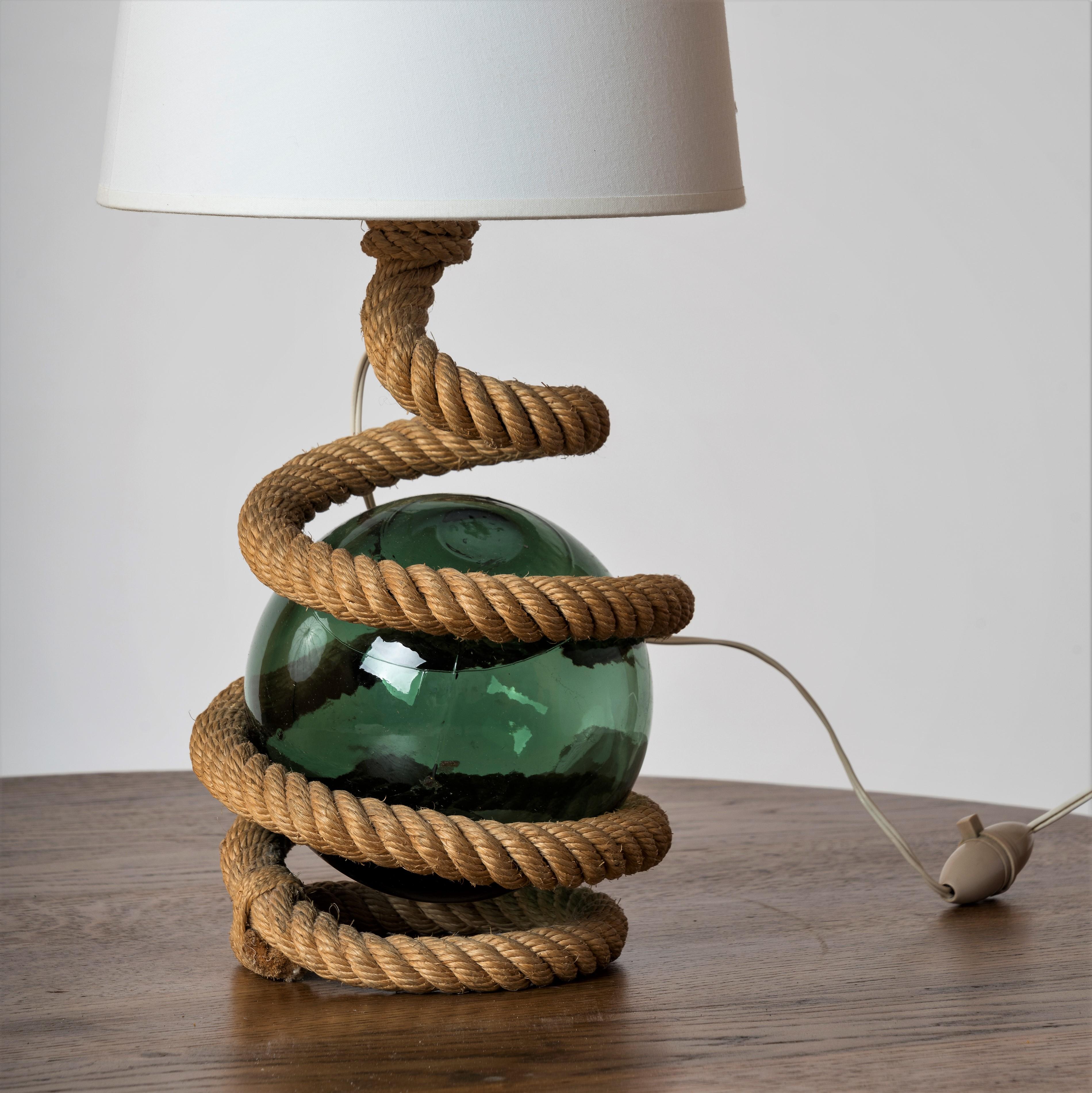 Serpentine rope table lamp with marine green glass ball in the center. Most likely by French iconic designers Adrien Audoux and Frida Minnet from the French Riviera region. Typical of 1960's production.
French bayonet bulb socket. European wiring.