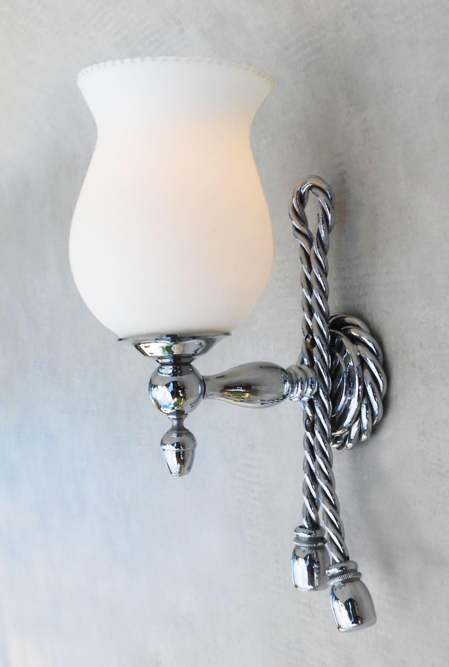 Beautiful pair of ‘Rope and Tassel’ sconces from Maison Bagues, France circa 1970. Stylish, French wall lights in chrome and satin-finished opaline glass. Twisted and coiled rope-like design finished with a jaunty offset double tassel. 
A