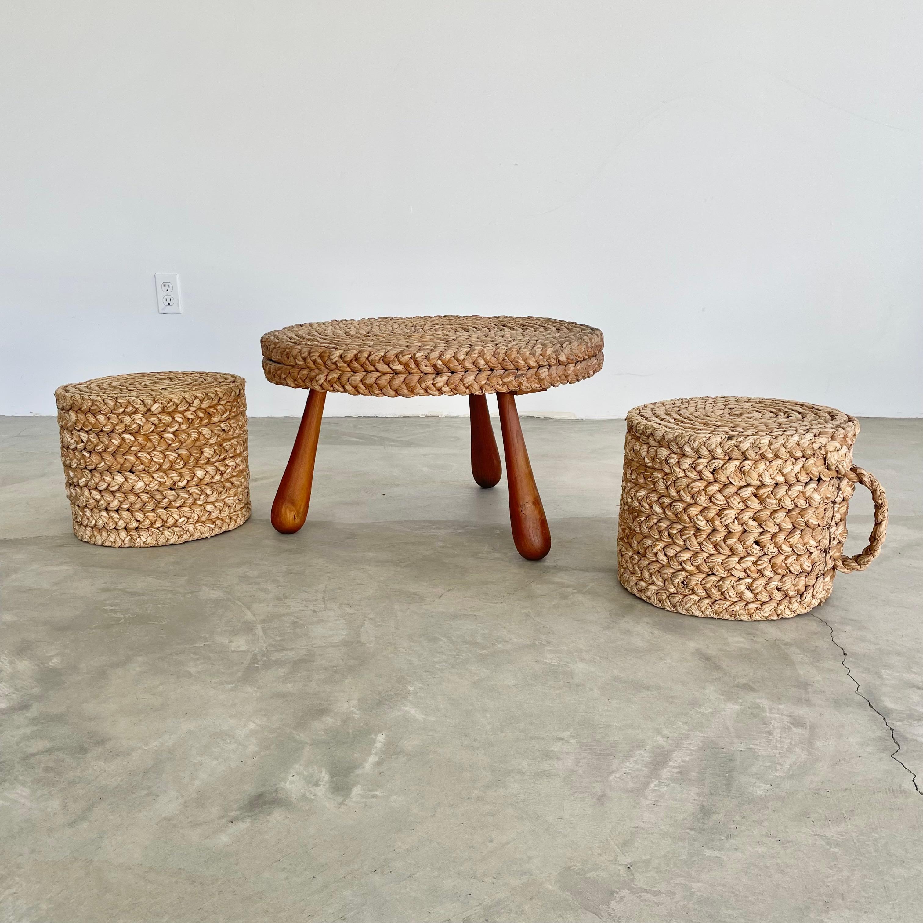 Unique tripod rope and wood table with two matching rope drum stools with woven handles. Cork table covered in rope sitting atop three sculptural club legs. Low profile set with amazing presence. Perfect indoors or in a covered patio. Rope is woven