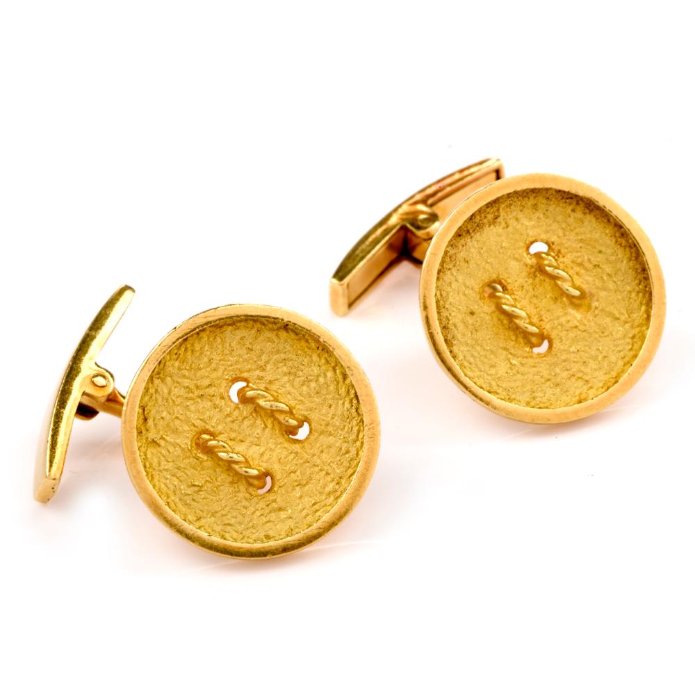 These playful and fashionable button cufflinks are crafted in 18-karat yellow gold, weighing 12 grams and measuring 18mm. Simulating buttons embellished with rope gold details and a textured finish. Signed ‘MR’ and in excellent condition.

 This
