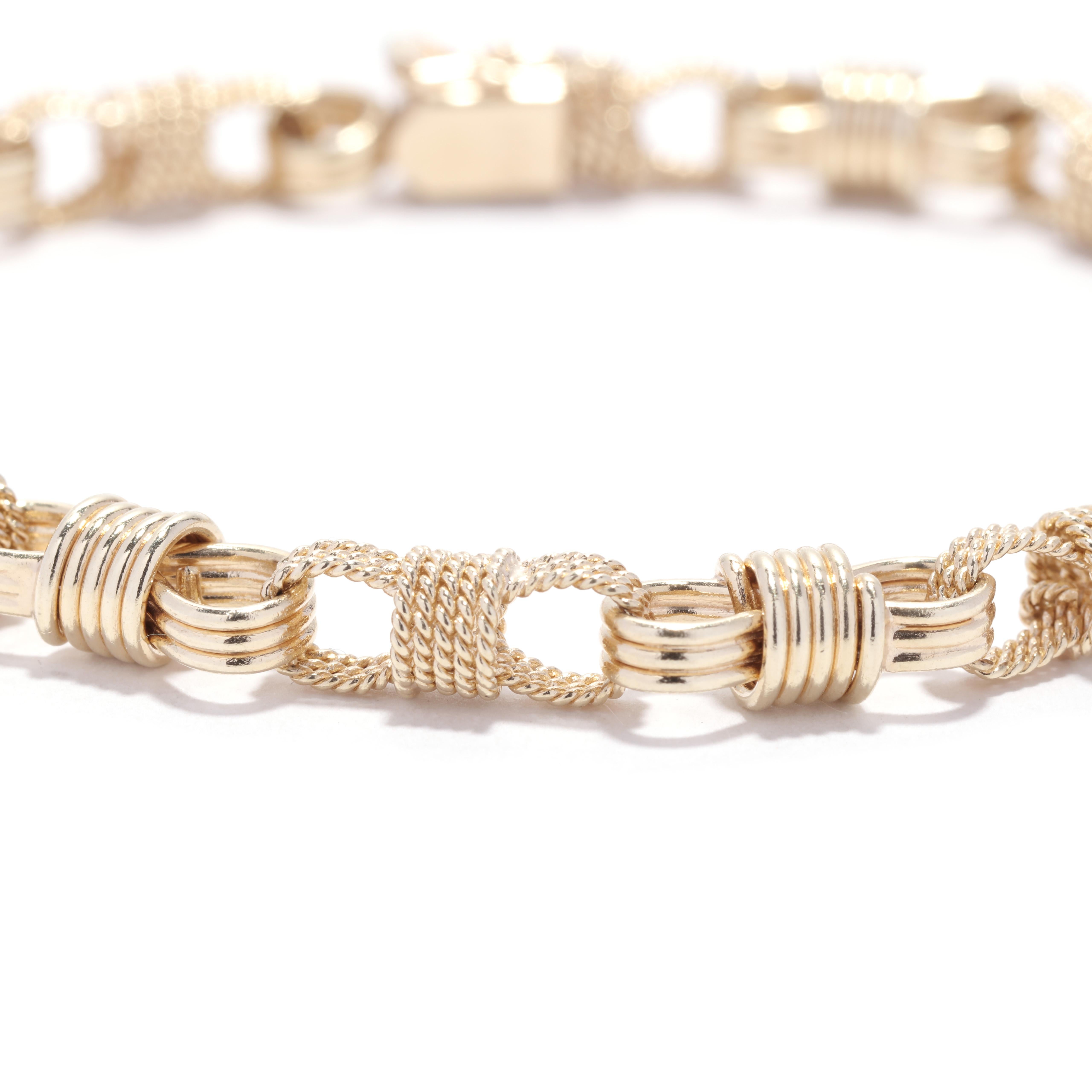A vintage 14 karat yellow gold rope knot link bracelet. This simple stackable bracelet features alternating rope motif and plain figure eight knot links and with a box clasp.

Length: 7.5 in.

Width: 1/4 in.

Weight: 11.1 dwts. / 17.26