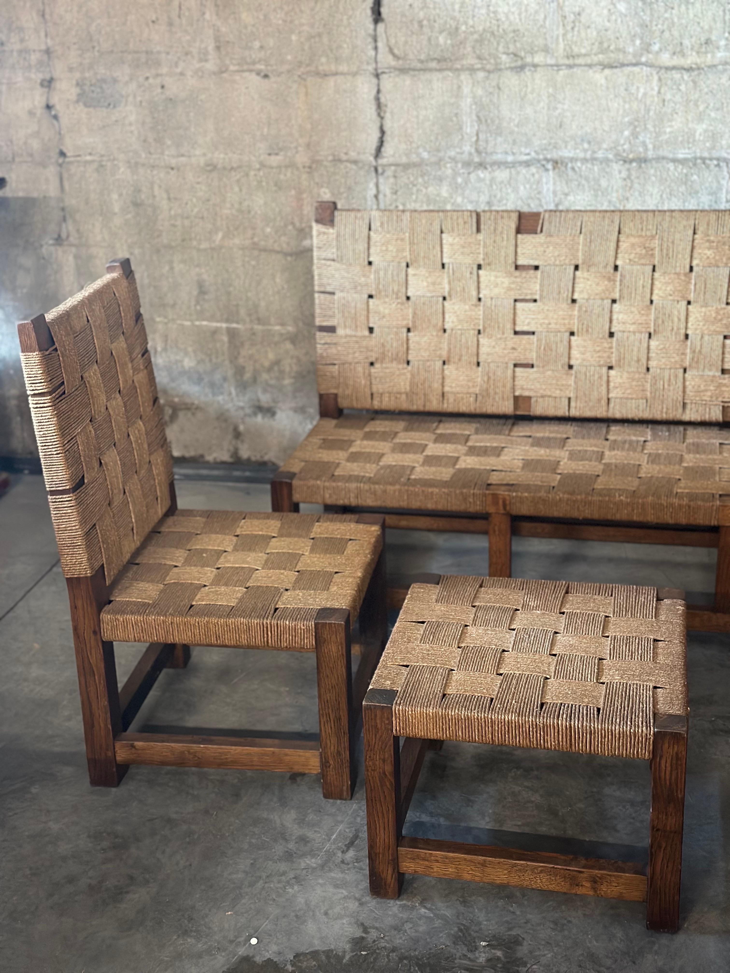 A beautiful lounge set, in the style of extraordinary French designer Francis Jourdain. Rushed rope and solid oak makeup the pieces. One couch, 2 chairs and 2 footstools/sidetables. A sturdy and unique collection. 