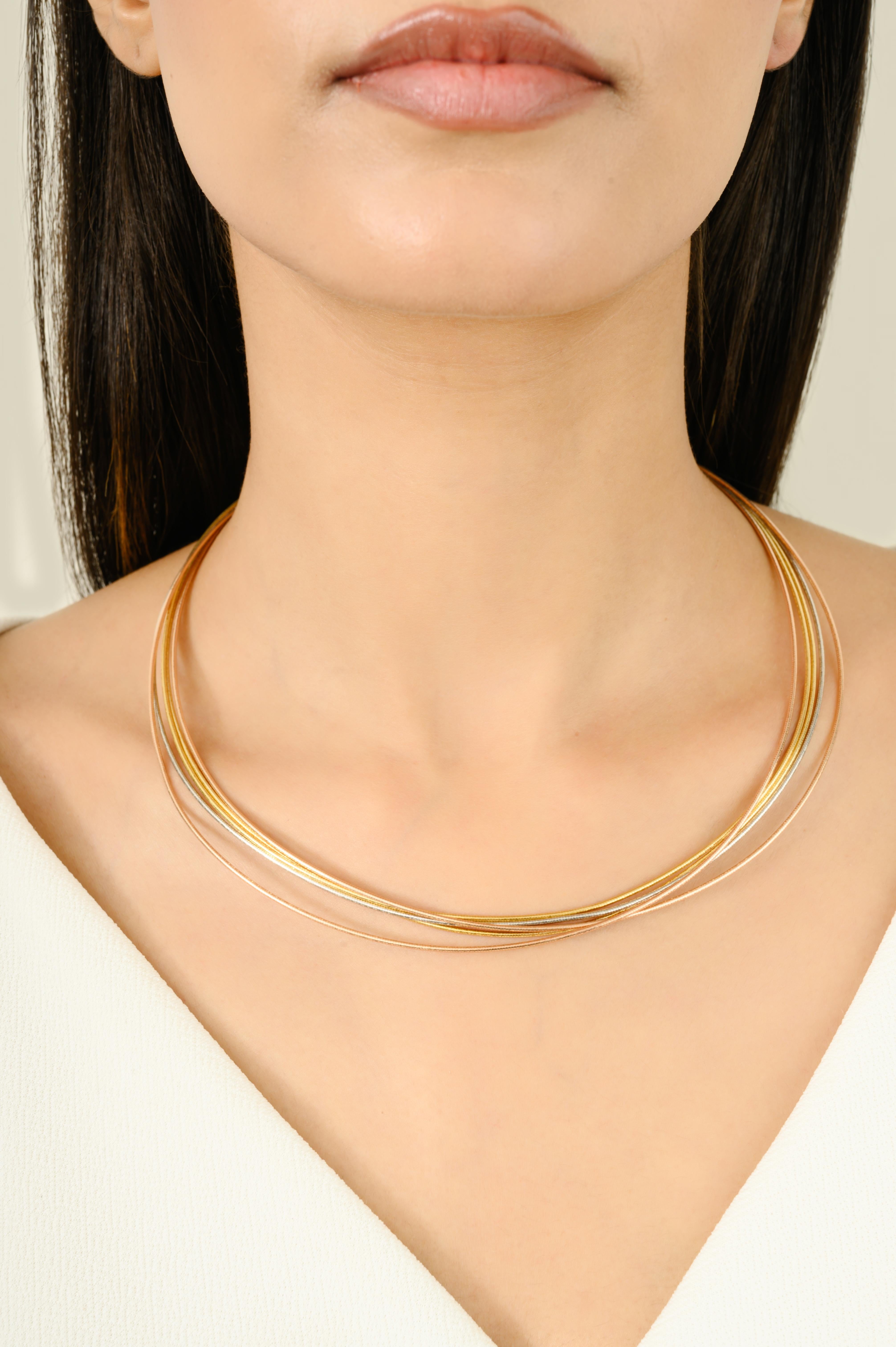 The Rope Triple Tone Silver Wired Choker Necklace in sterling silver is a striking and sophisticated accessory designed to stand out. It features three captivating colors: rose gold, yellow gold, and white gold, skillfully intertwined to create a