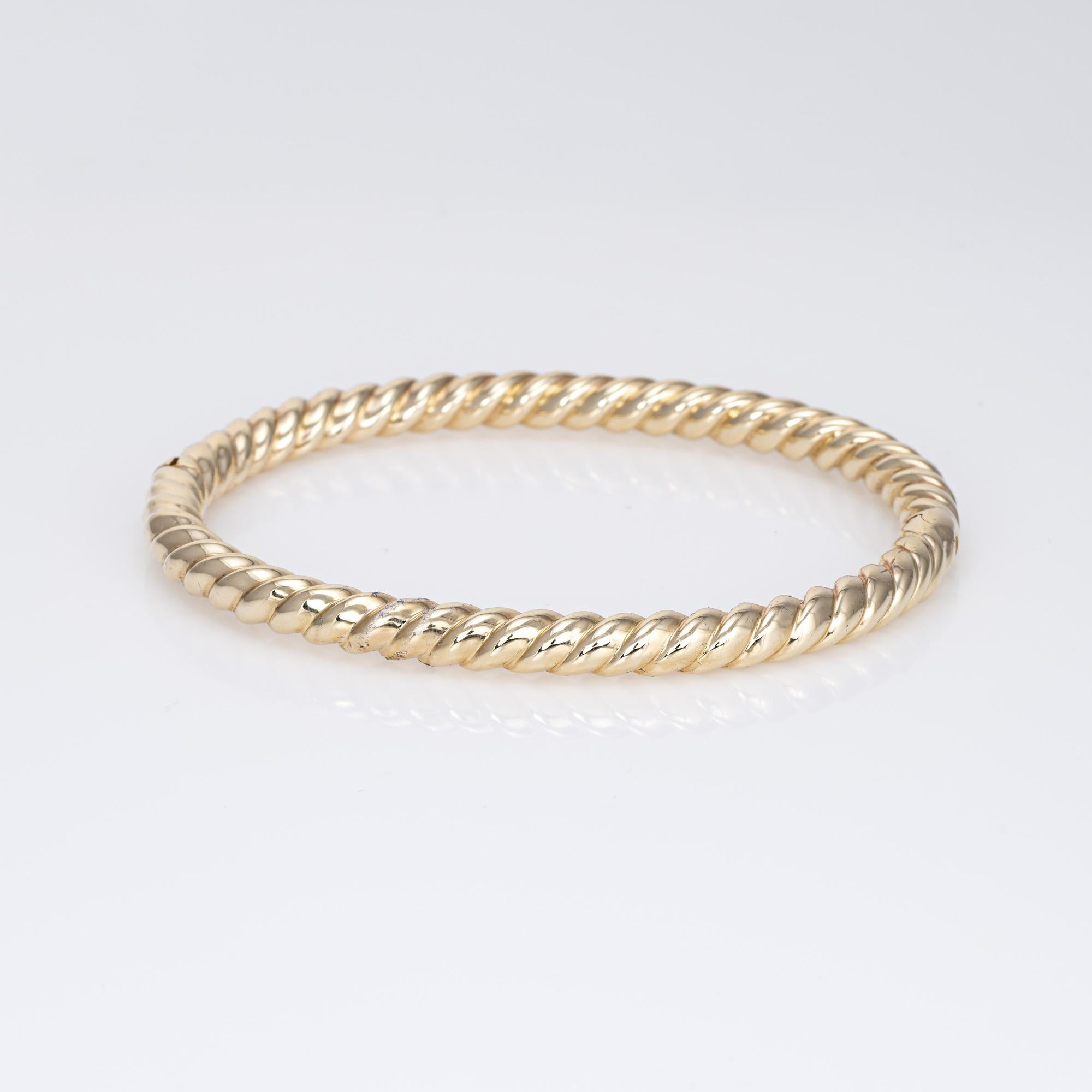 Stylish and finely detailed vintage rope twist bangle bracelet crafted in 14 karat yellow gold. 

The simple and elegant bangle bracelet features a rope twist design. The bracelet is great worn alone or layered with your fine jewelry from any era.  