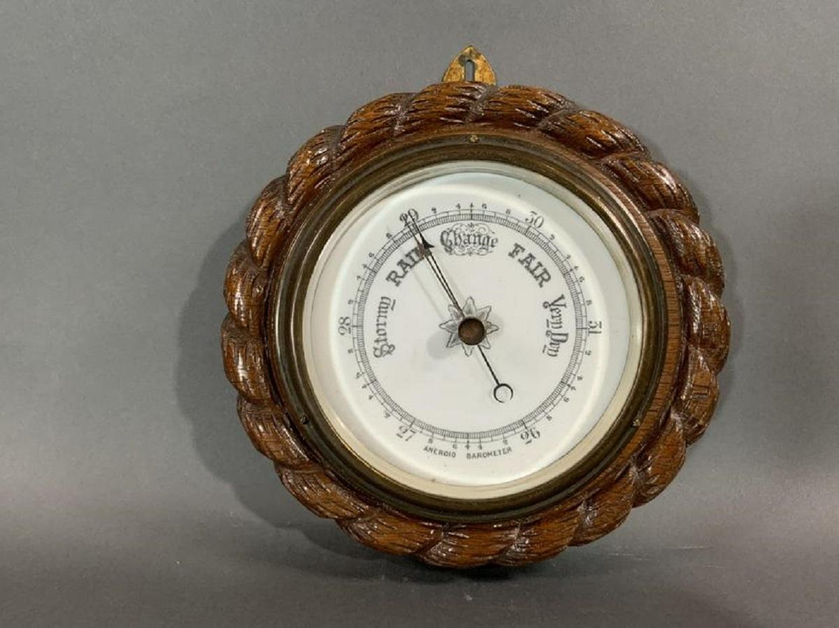 Early twentieth century English made barometer with porcelain face. Oak rope twist case. With brass hanging tab.

Overall dimensions: Weight is 2 pounds. 8