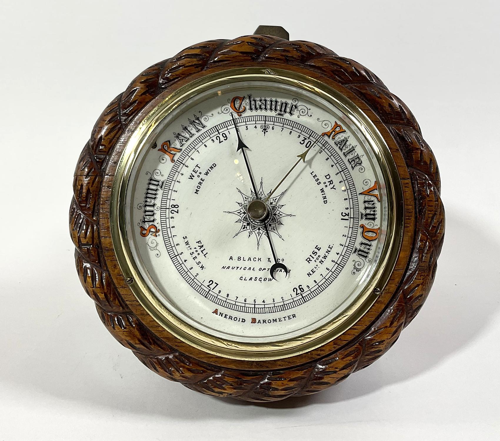 Early twentieth century barometer with porcelain face with merchants name A Black & Co., Nautical Optician, Glasgow. Carved rope twist case with brass bezel. Brass hanging tab. Nice nautical relic.
