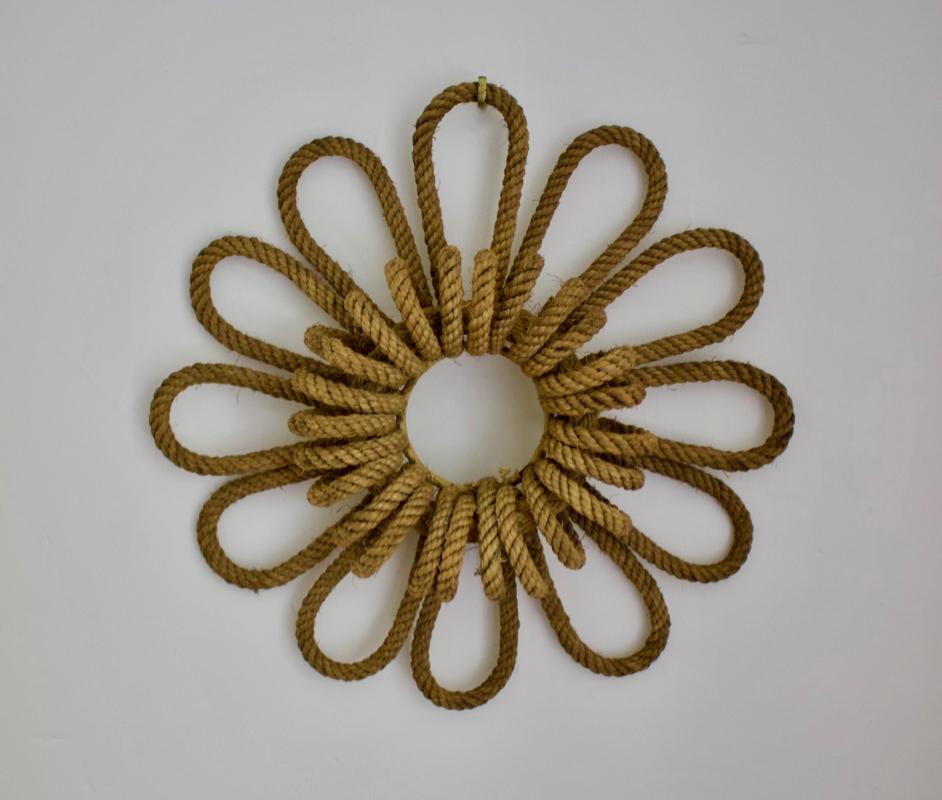 A decorative object in the shape of a simple flower, found in France, 20th century.

Made of thick rope over metal, very much in the style of Adrien Audoux and Frieda Minet.  Hard to define clearly, but a nice thing - we have shown it here as a
