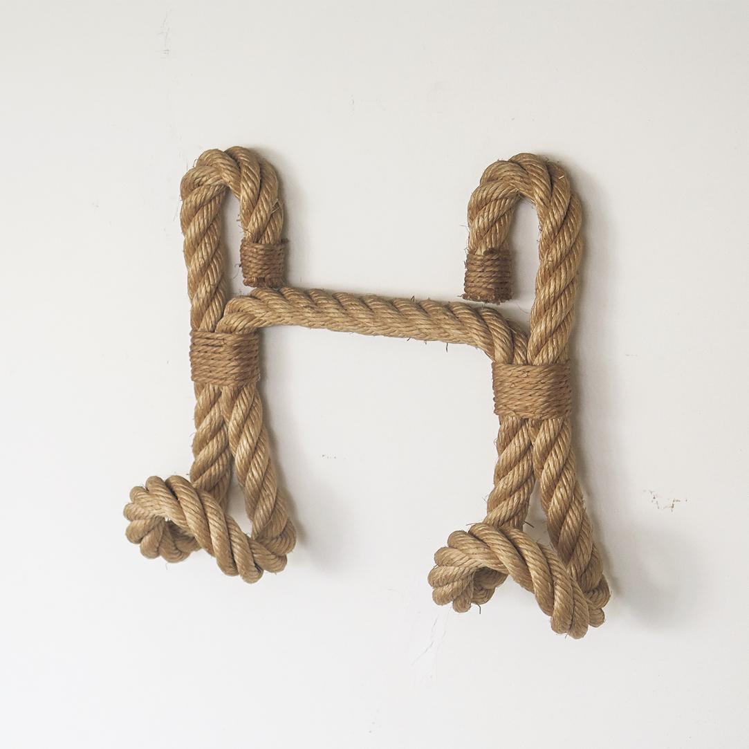 Beautiful French 1950's wall hook made of thick twisted rope and twine by Audoux-Minet. Two tongue shaped hooks, perfect to hold hats or coats.